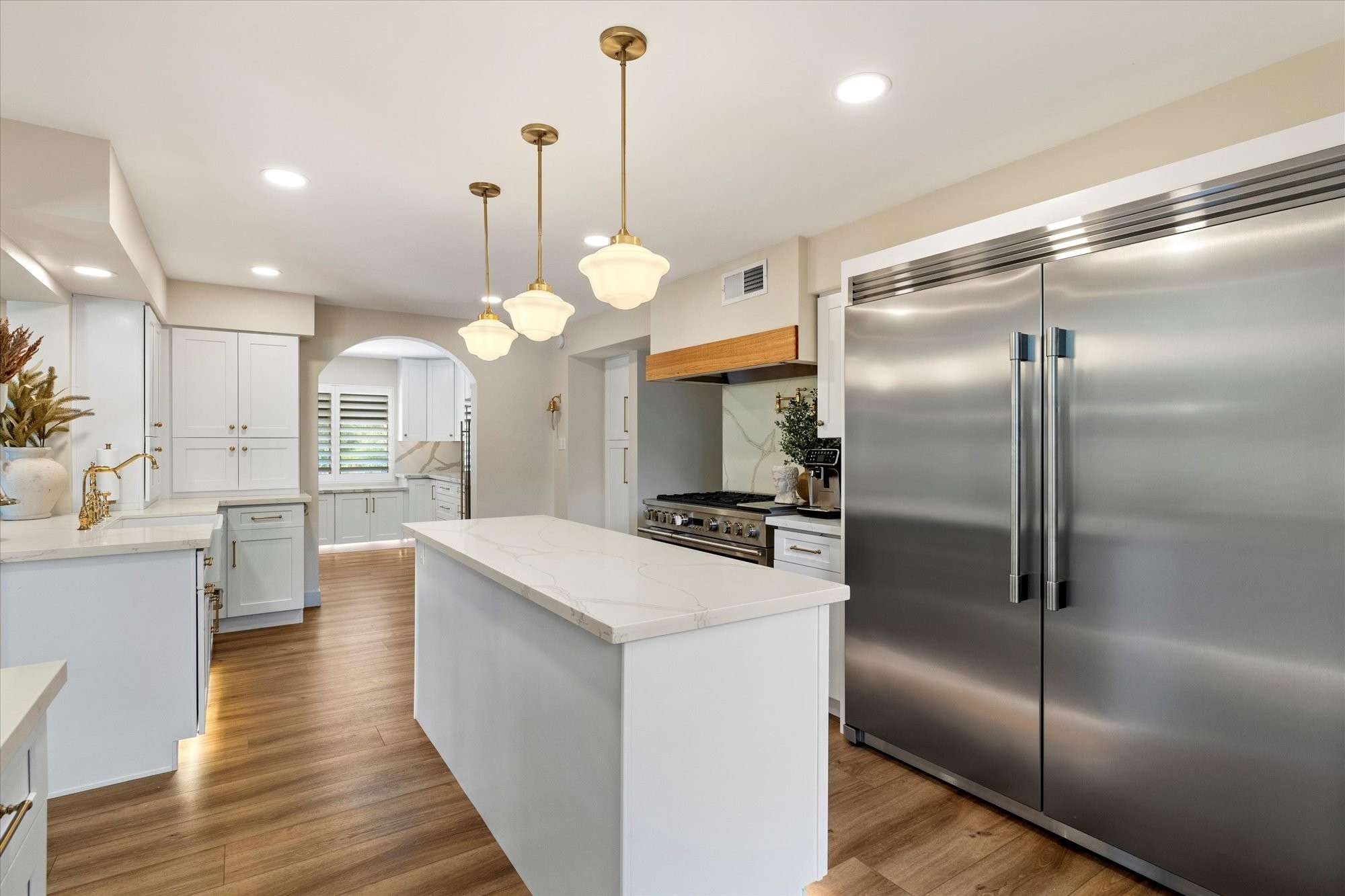 5 of 48. Beautifully designed kitchen featuring a professional gas range, large island workspace, and seamless connection to dining areas.