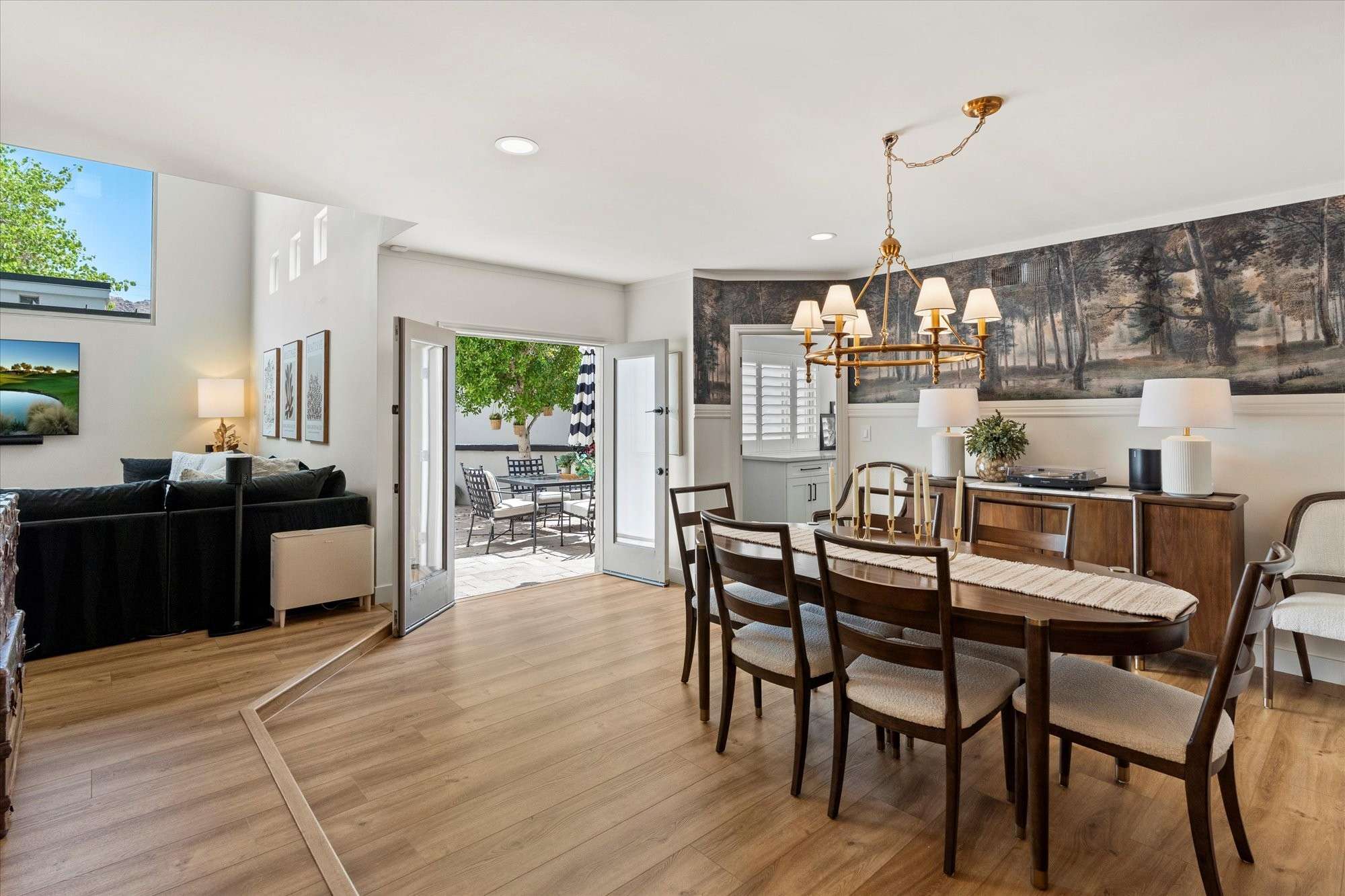 9 of 48. Sophisticated dining space accented by a statement chandelier, wood floors, and natural light for formal or casual meals.