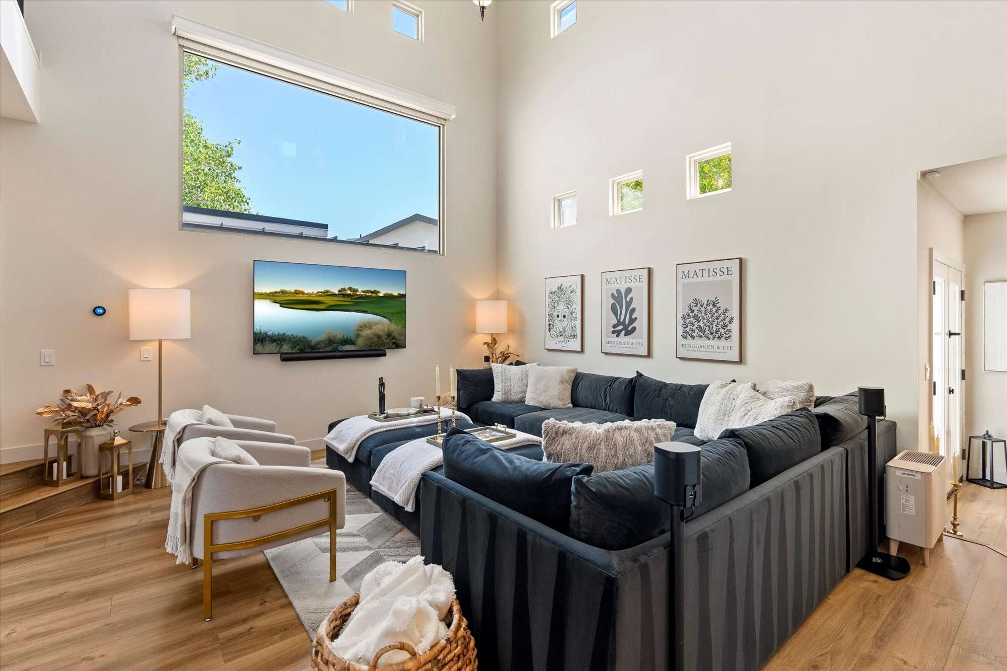 15 of 48. Bright great room featuring expansive windows, high ceilings, and an open floor plan perfect for entertaining and everyday comfort.