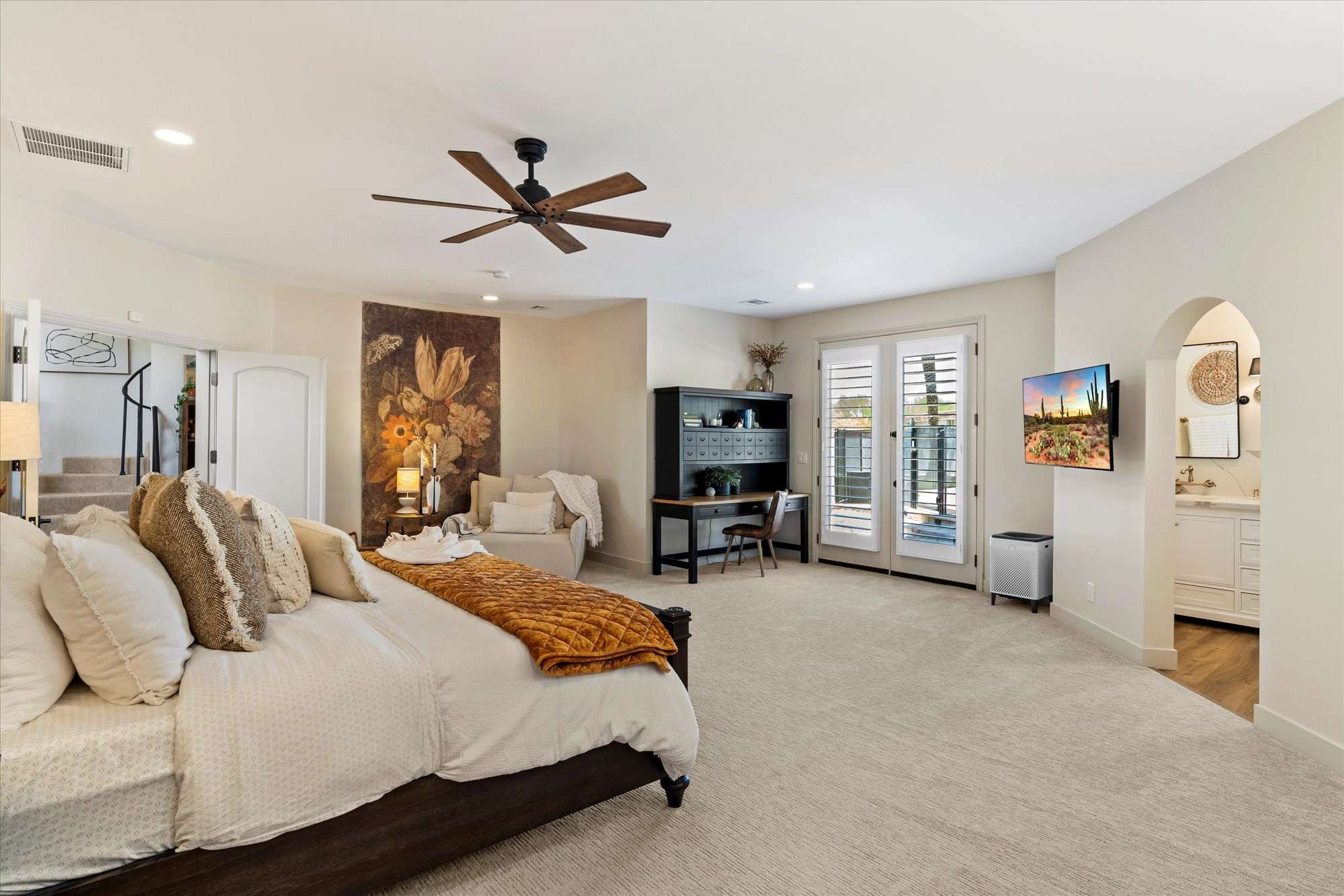 18 of 48. Oversized primary bedroom offering a private lounge area, soft carpeting, and calming finishes for a relaxing retreat.