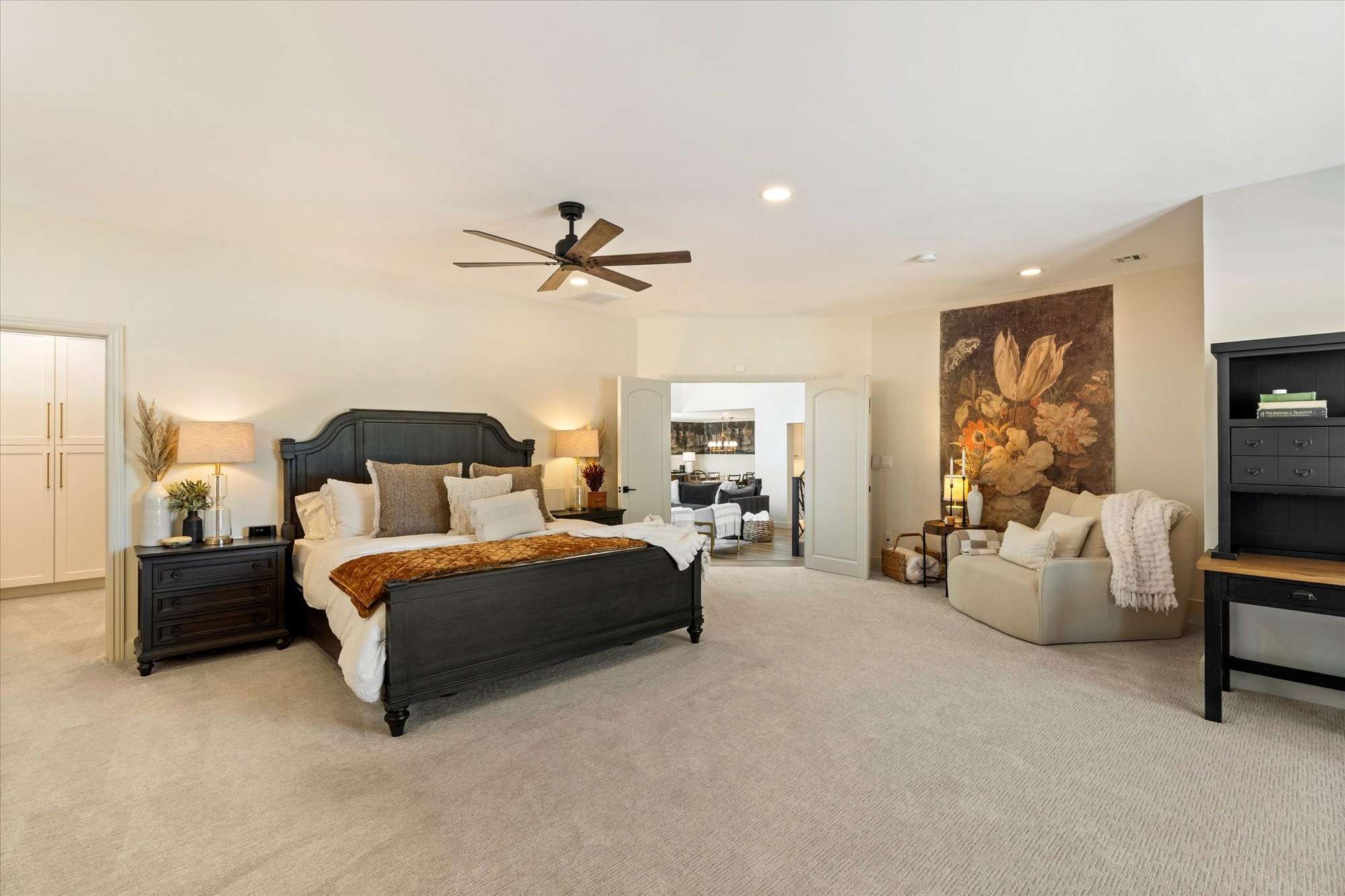 19 of 48. Thoughtfully designed primary suite with generous proportions, seating space, and access to a spa-inspired bathroom.