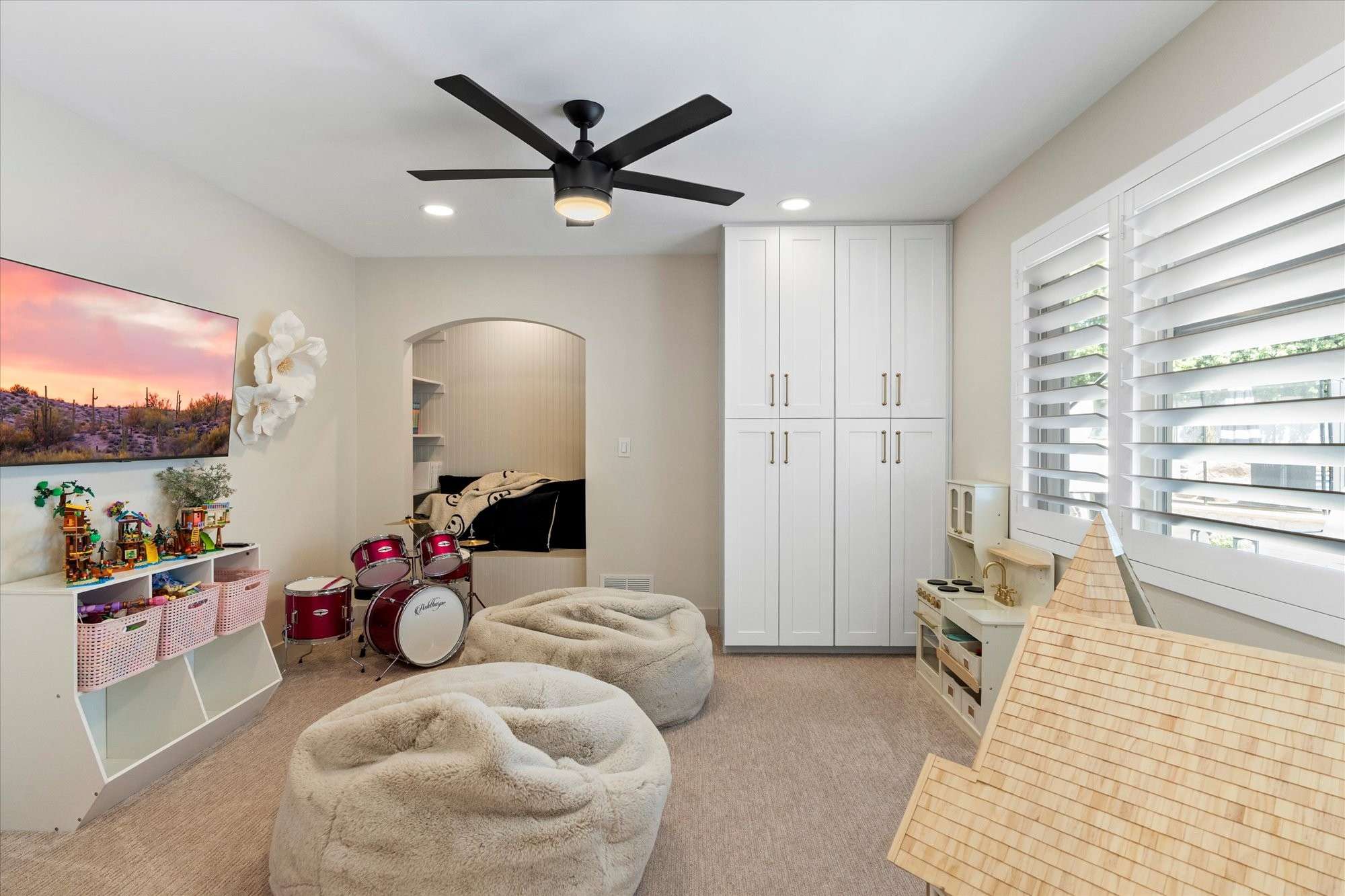 29 of 48. Guest bedroom with custom built-ins, ample storage, and plantation shutters providing versatility and everyday comfort.