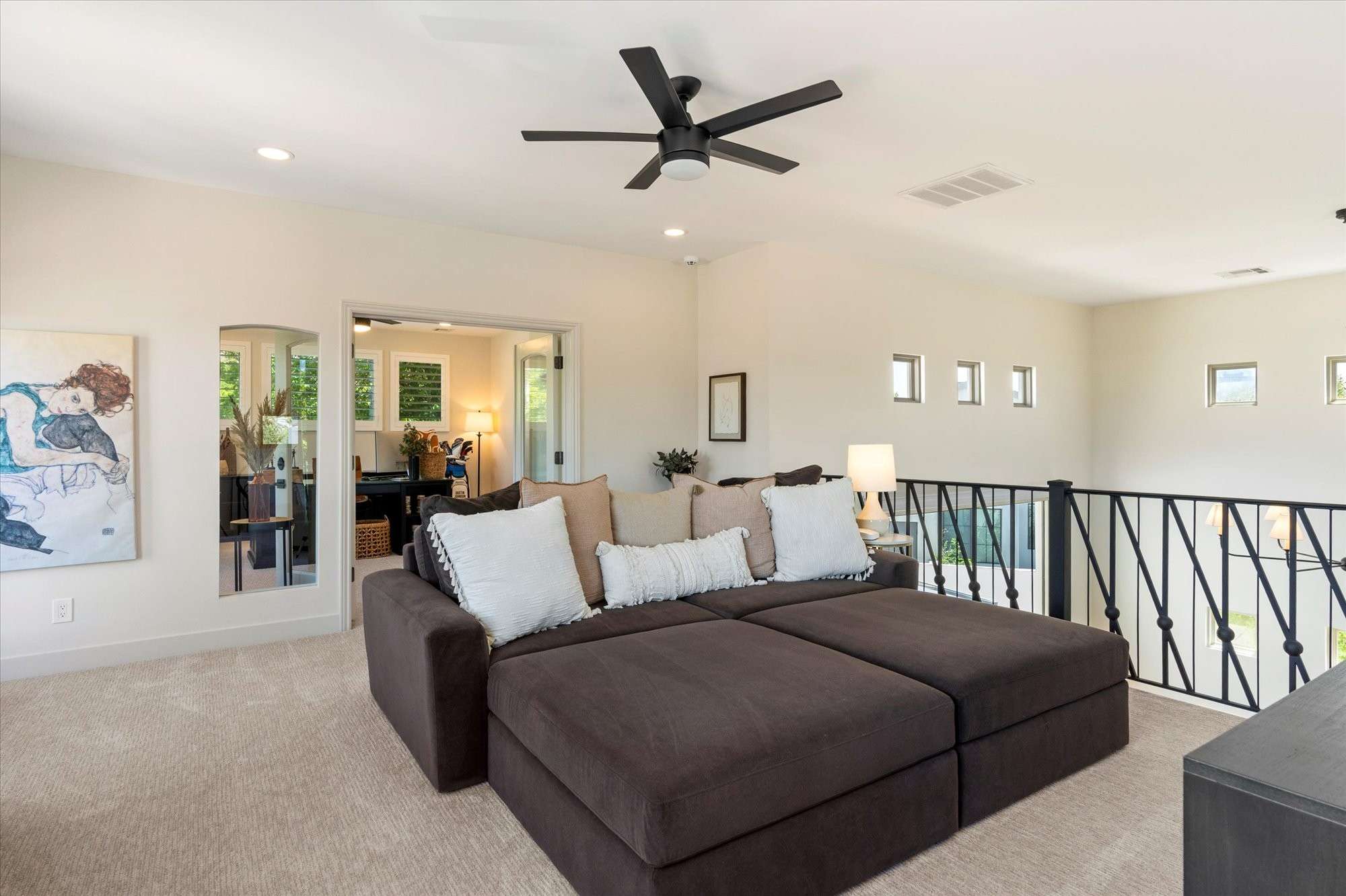 32 of 48. Comfortable loft space with plush carpet and ceiling fan, ideal for lounging, media use, or secondary living area.
