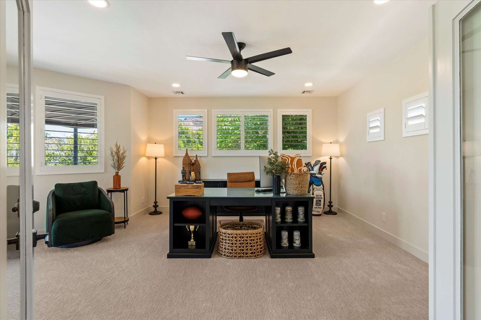 34 of 48. Bright and versatile room suitable as a guest bedroom or home office, featuring soft carpet, ceiling fan, and clean modern finishes.