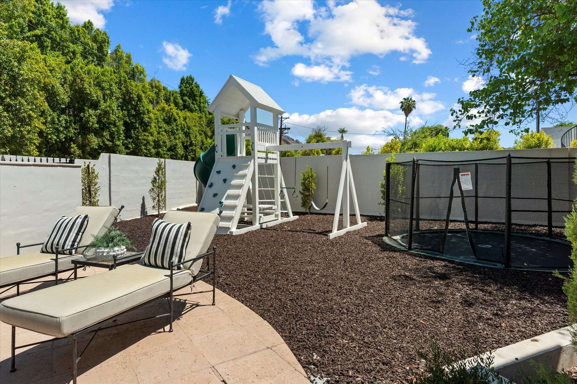 43 of 48. Private backyard play space with custom equipment, clean landscaping, and room to enjoy outdoor living year-round.