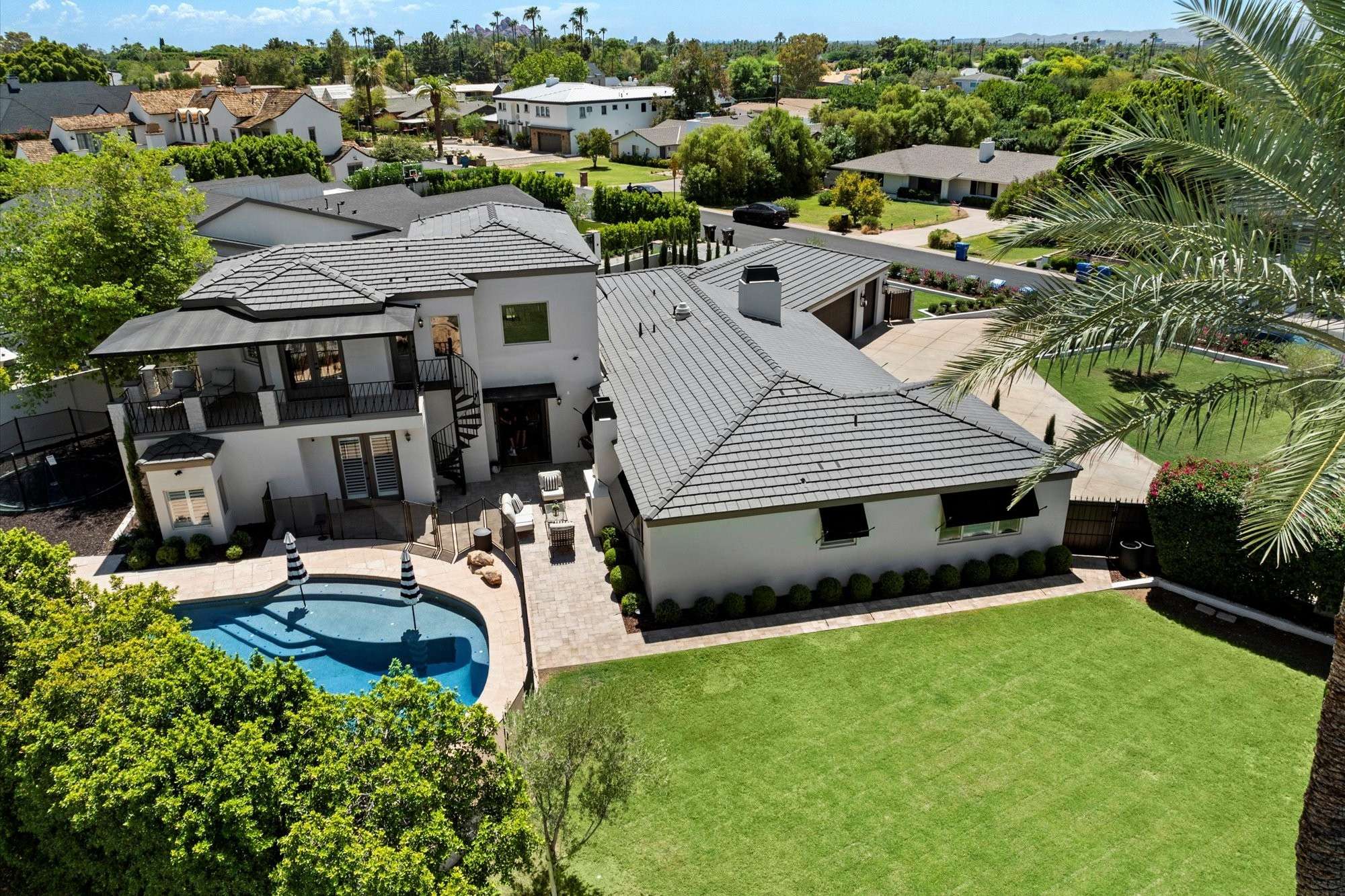46 of 48. Aerial view highlighting the balance of lawn, pool, and outdoor living spaces within this expansive Phoenix backyard.