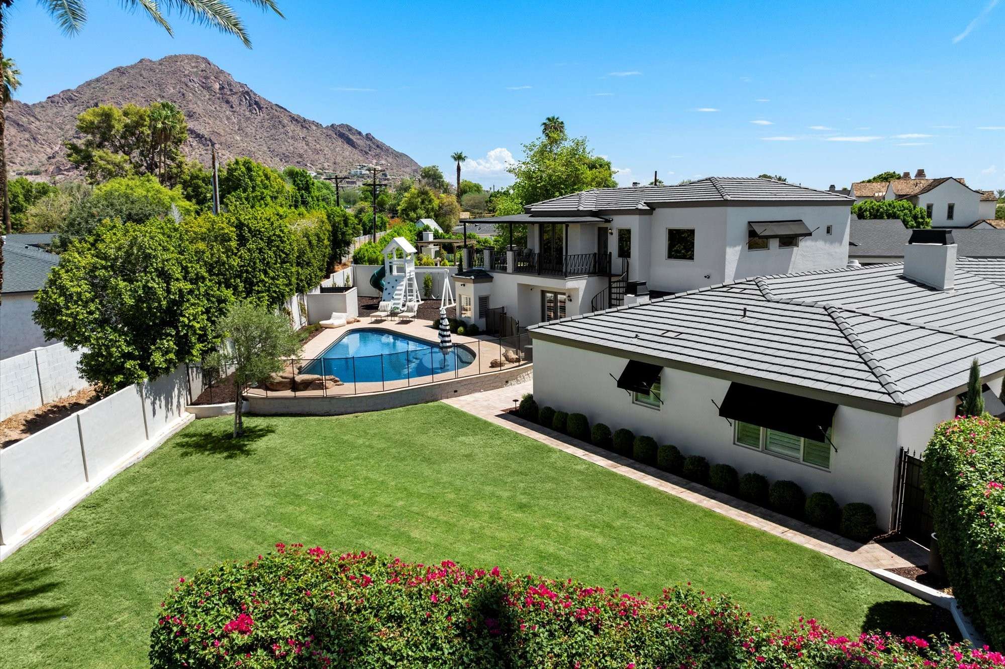 47 of 48. Overhead view emphasizing the pool design, lawn areas, and seamless layout of the backyard and home.