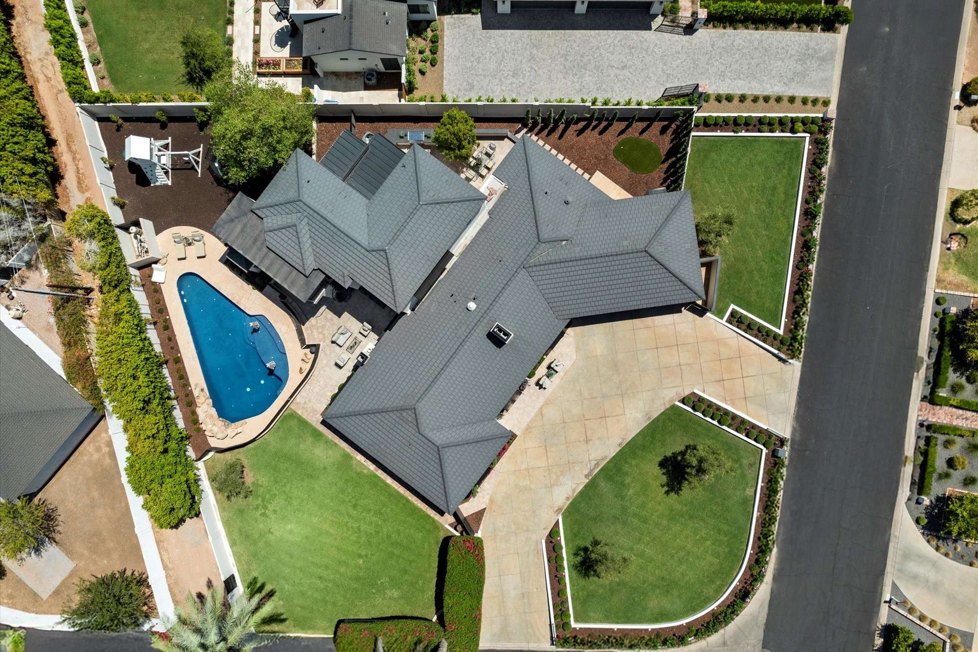 48 of 48. Bird s-eye view capturing the entire property, including the home, backyard amenities, lawn, and outdoor living features.