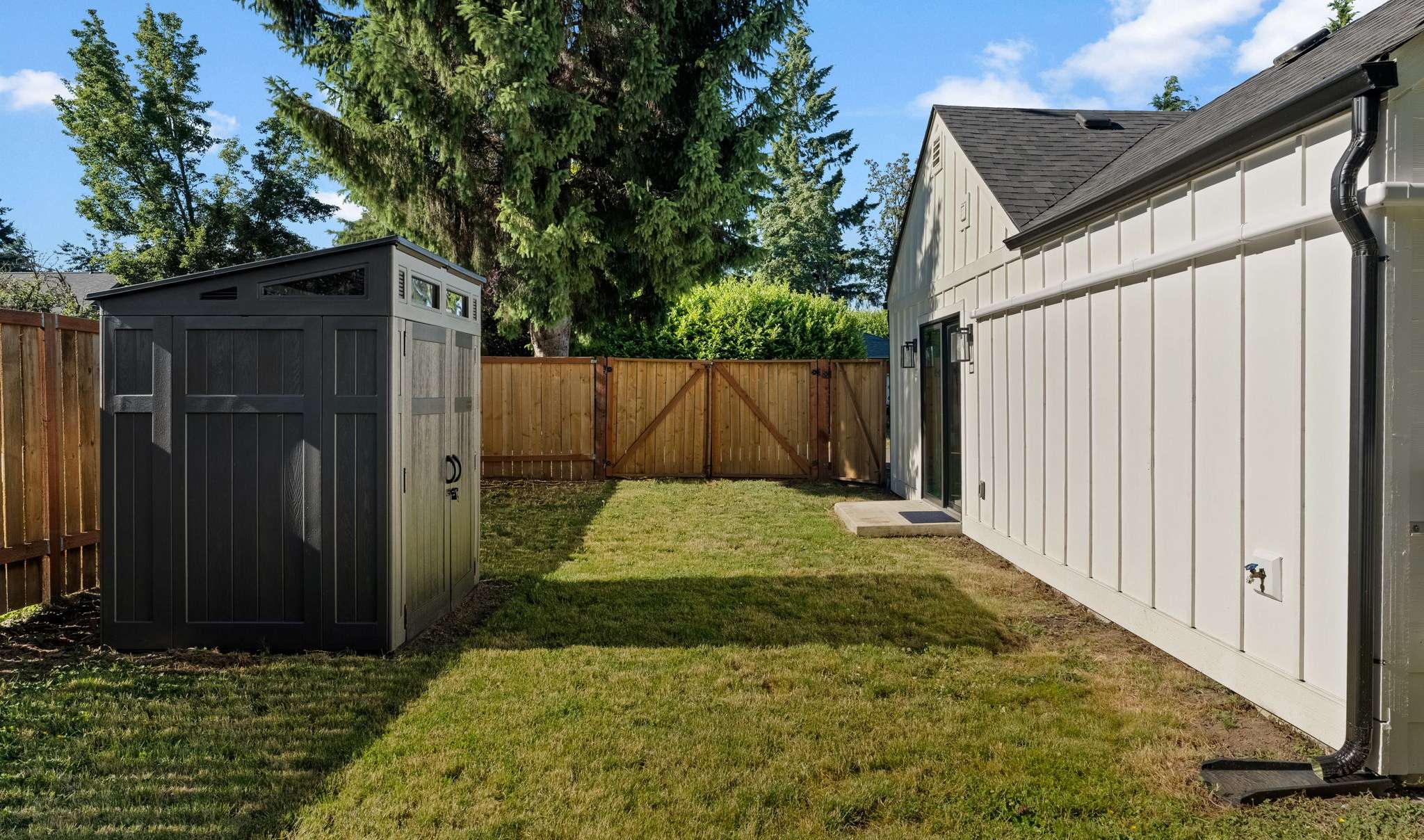29 of 33. Storage shed, double-gate, and separate single-gate entrance