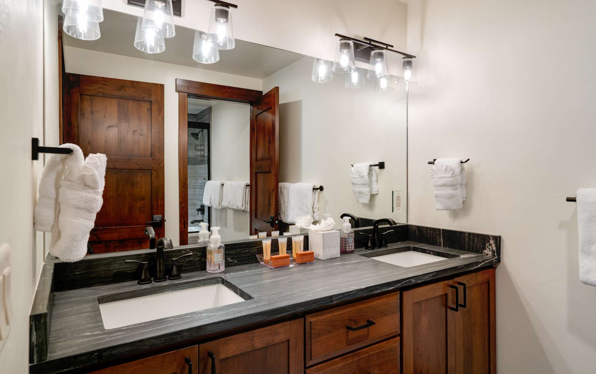 31 of 42. Bunk room en suite bathroom featuring sleek countertops, contemporary lighting, and ample storage for everyday essentials.