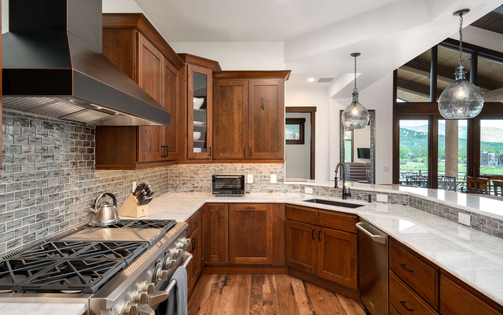 10 of 42. Beautifully designed gourmet kitchen featuring a 48" gas range, a 48 " built-in refrigerator, GE Monogram appliances, ample counter space, and counter seating.