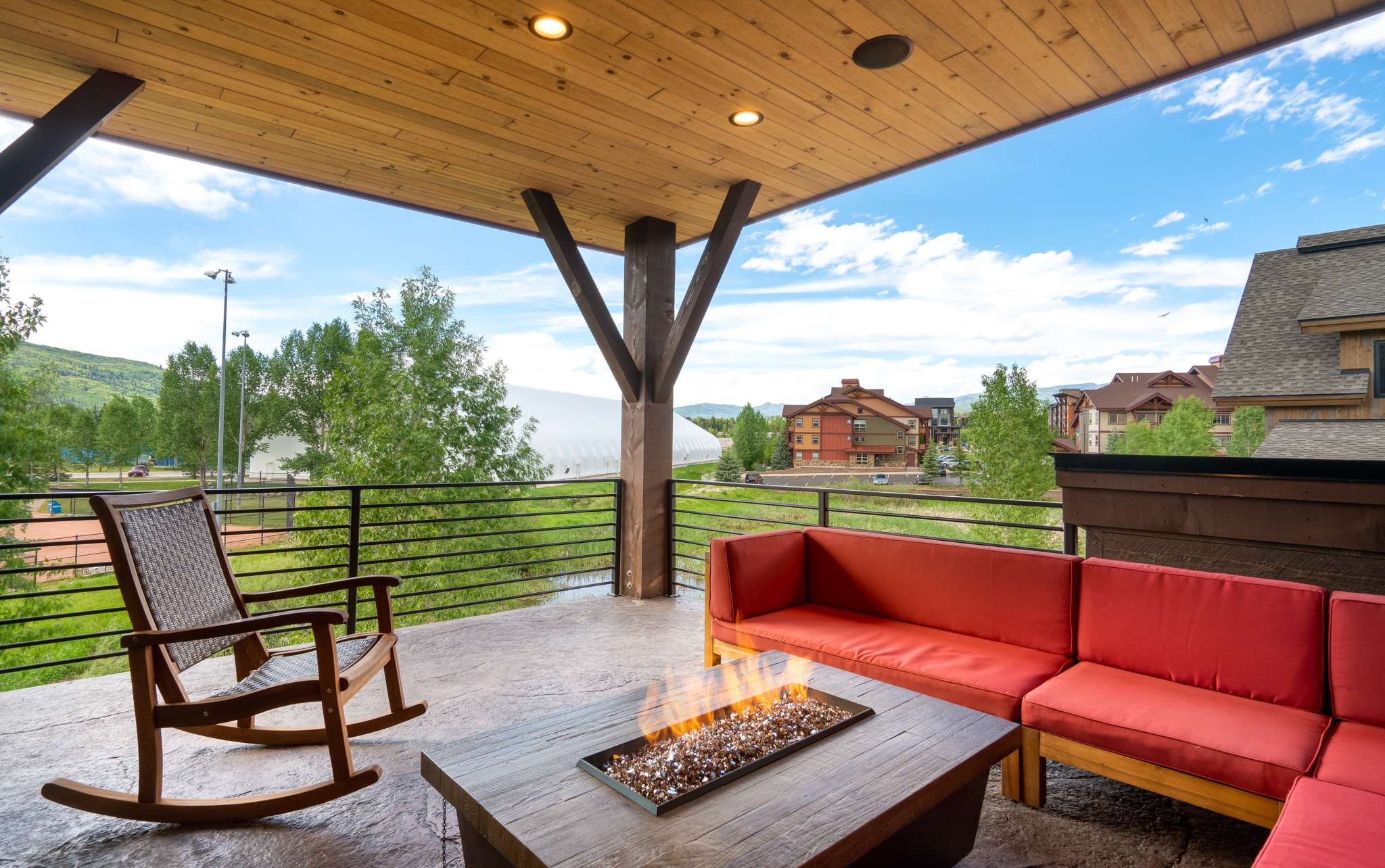 9 of 42. Spacious covered deck featuring Emerald Mountain views and a fire pit, perfect for outdoor relaxation and entertaining.