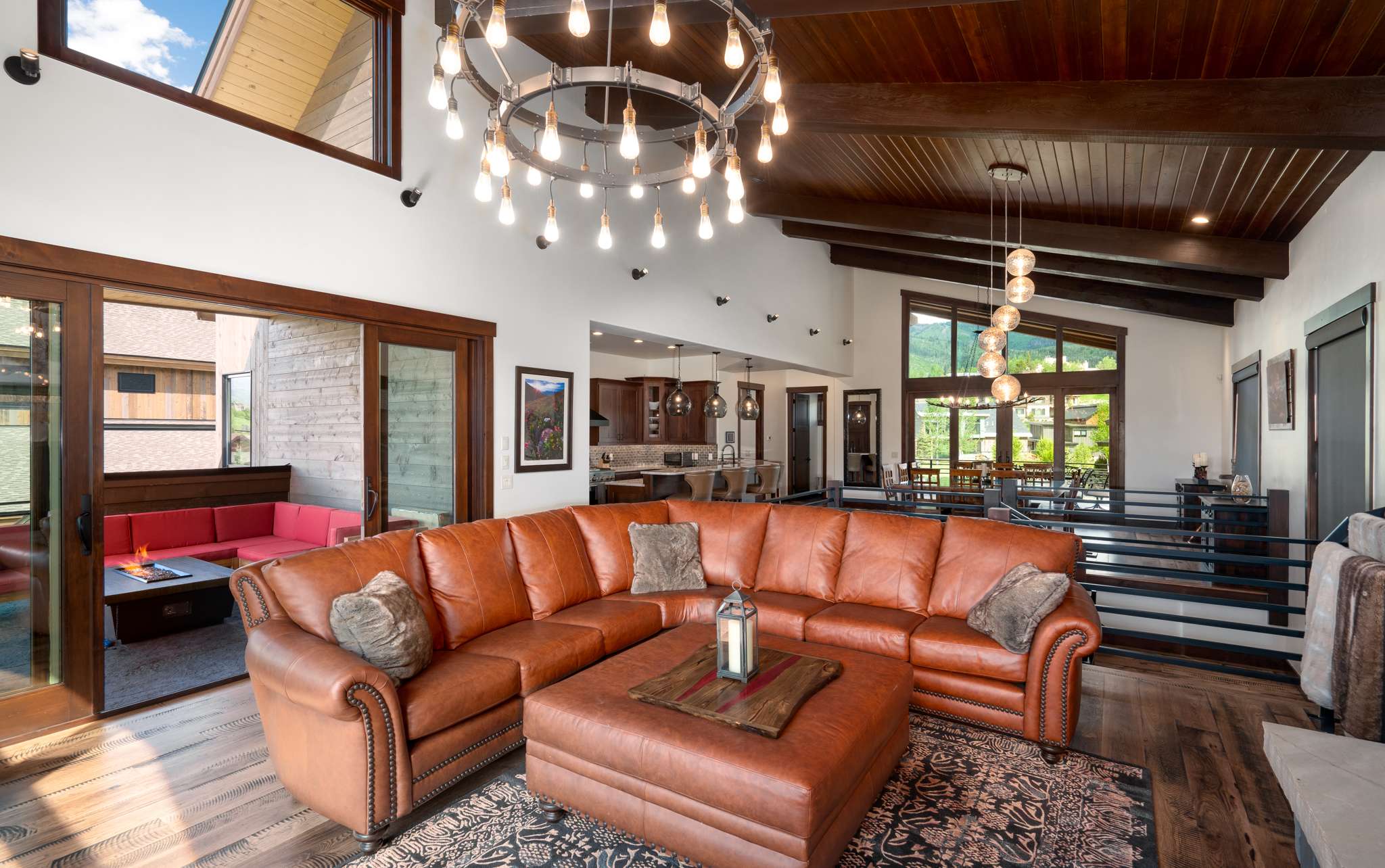 6 of 42. Spacious great room connects to the gourmet kitchen and dining areas. Sliding glass doors open to a back deck featuring Emerald Mountain views.