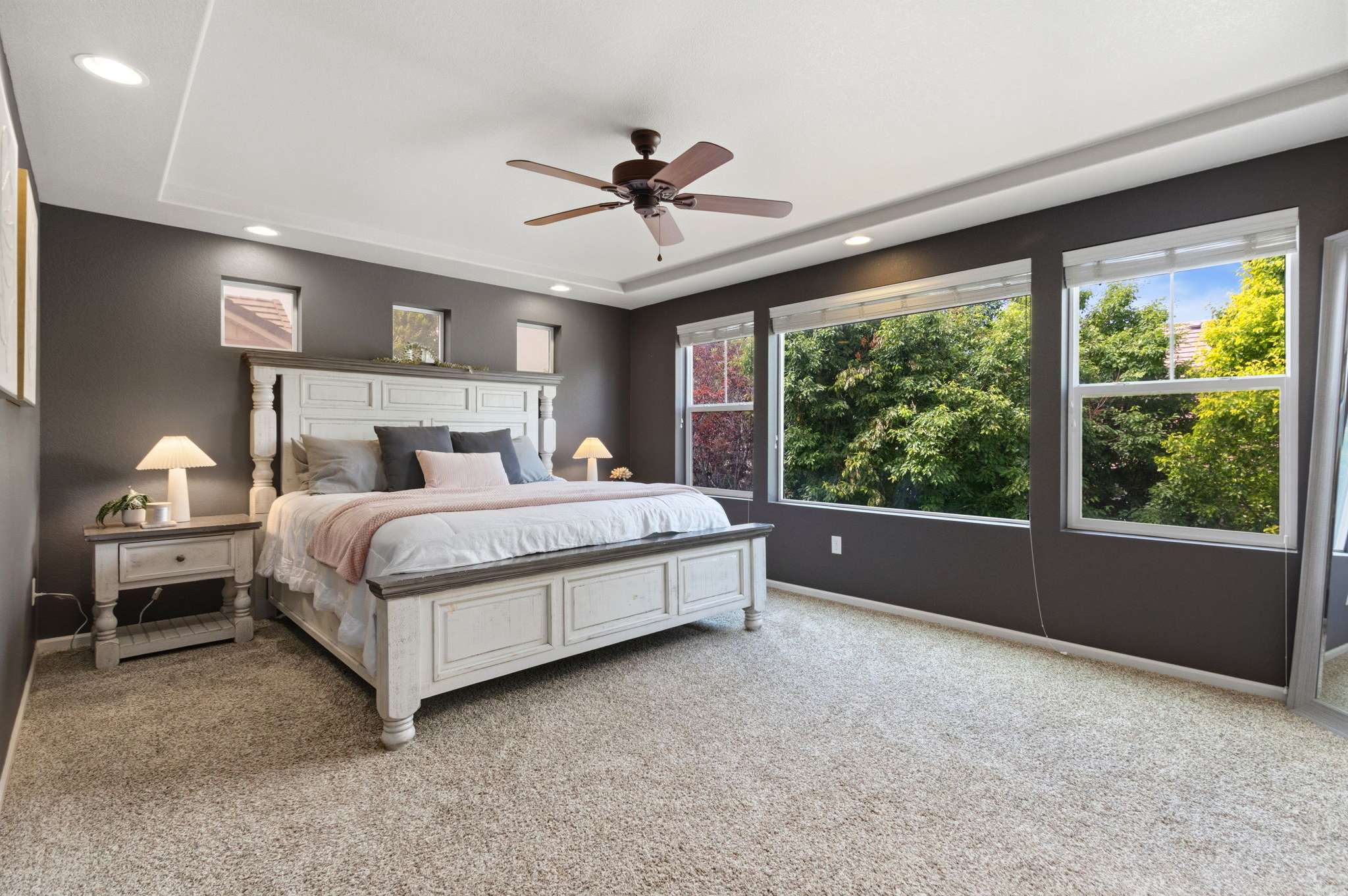 21 of 34. A large primary suite is positioned privately on the back of the home.