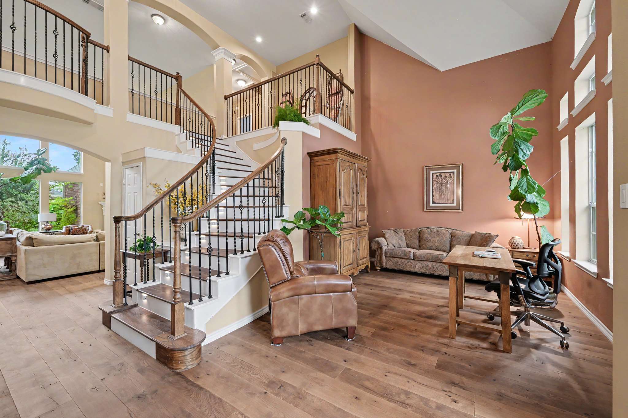 20 of 71. Welcoming entryway with a grand staircase, ample natural light, and flexible spaces for living and working.