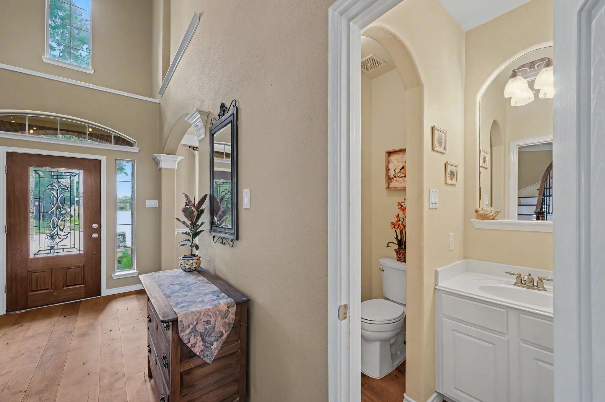 21 of 71. Spacious entryway featuring natural light, a welcoming atmosphere, and easy access to a convenient half-bath.