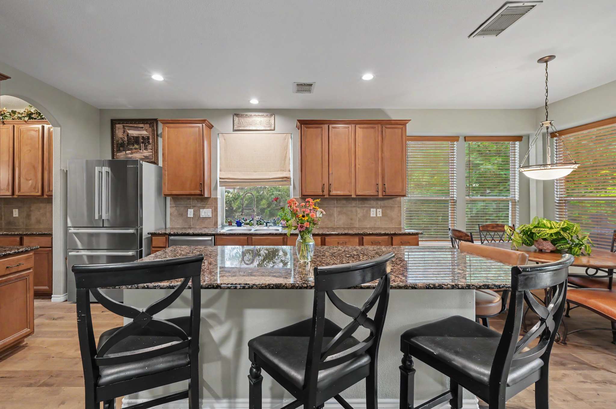 31 of 71. Bright and inviting kitchen features modern appliances, ample counter space, and a cozy breakfast area.