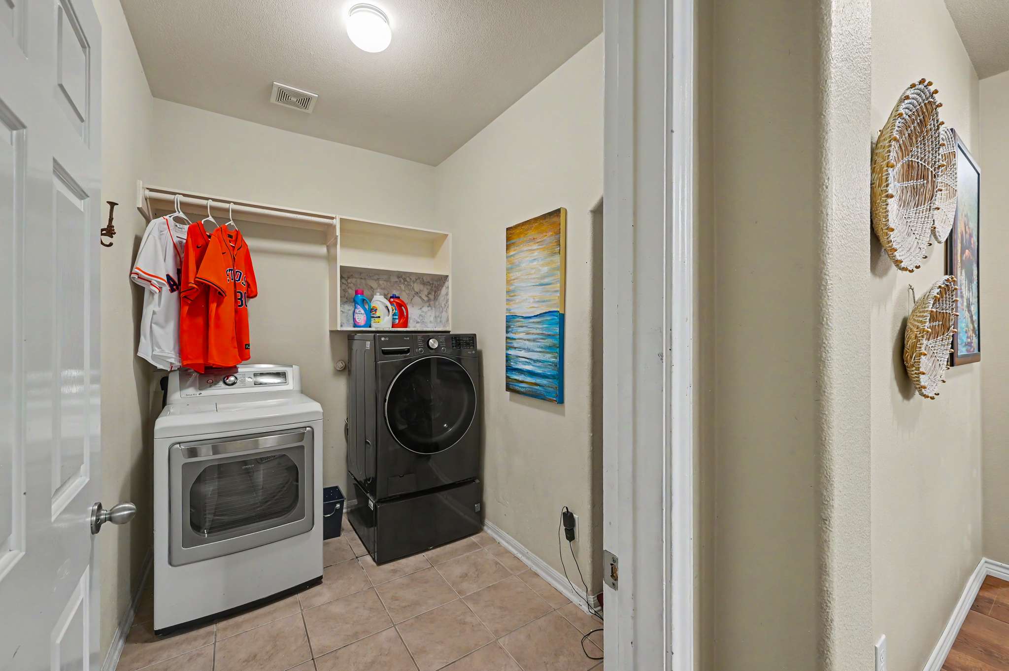 35 of 71. Spacious laundry room features modern appliances and convenient storage, ideal for efficient household management.