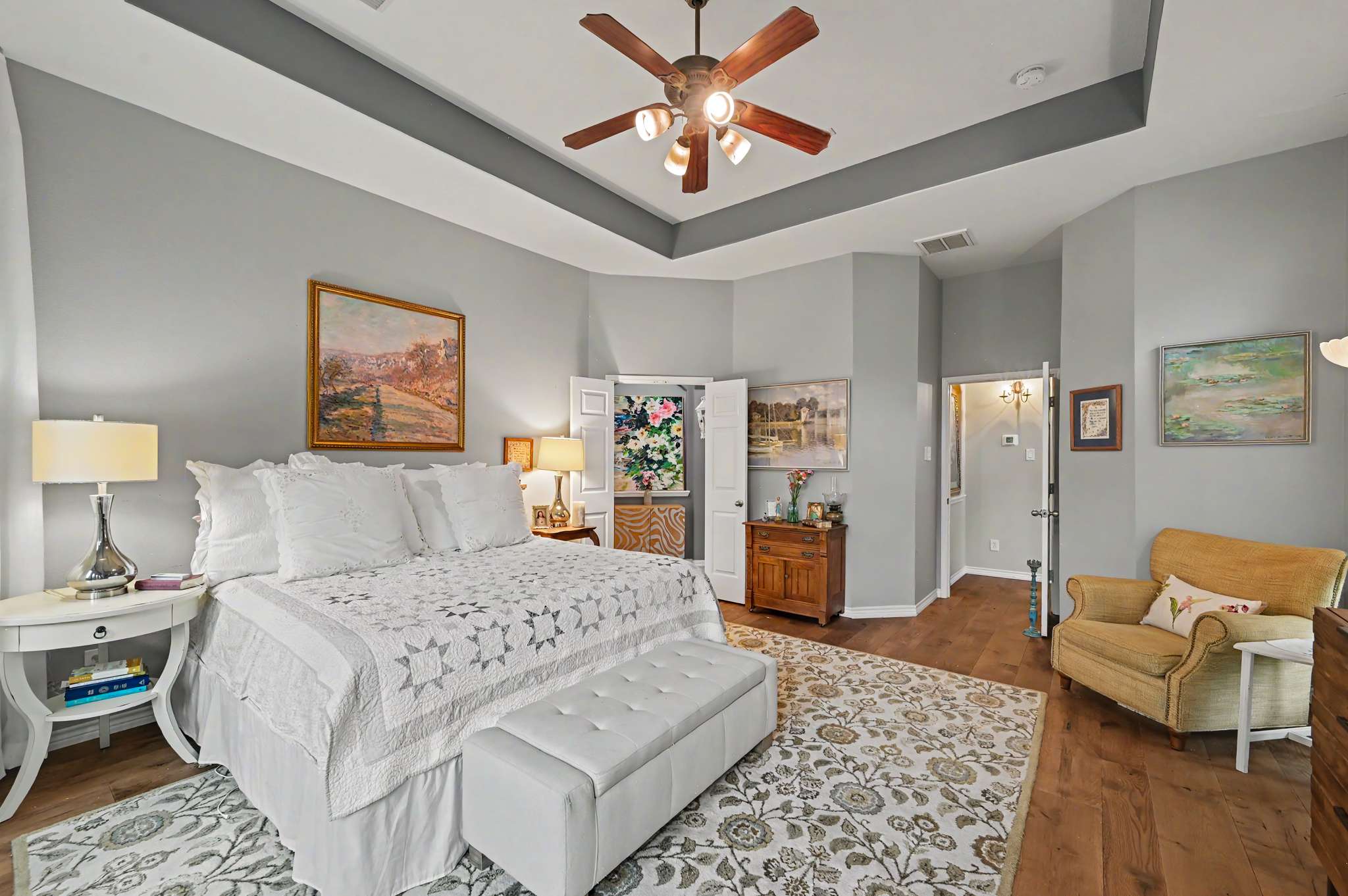 36 of 71. Spacious bedroom featuring vaulted ceilings, natural light, and an inviting layout for relaxation and comfort.