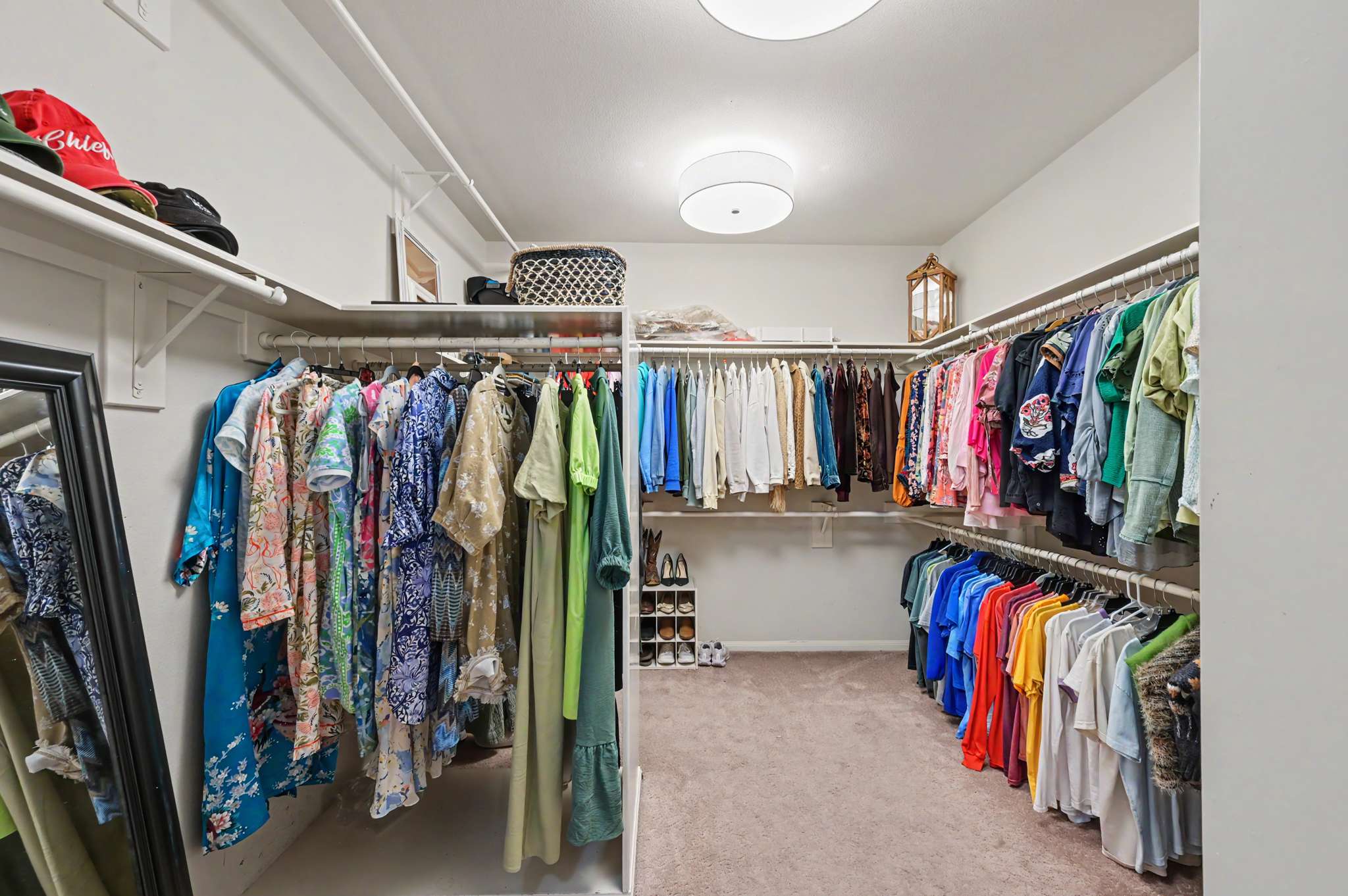 41 of 71. Spacious walk-in closet featuring ample storage for an extensive wardrobe and organized display options.