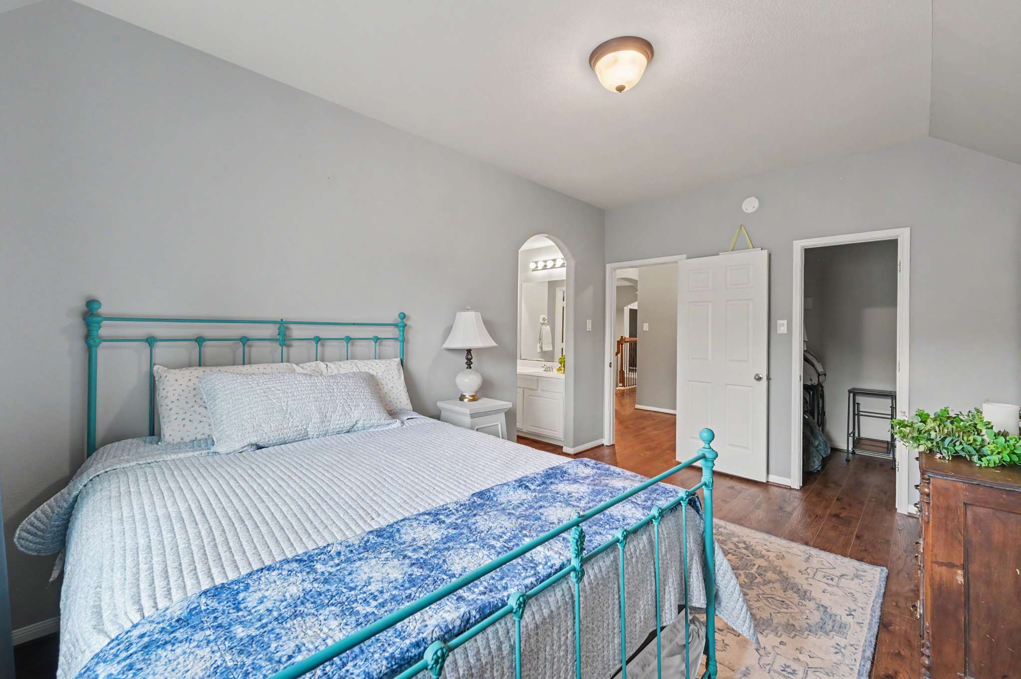 44 of 71. Bright and welcoming bedroom featuring a cozy layout, vintage metal bed frame, and ample natural light.