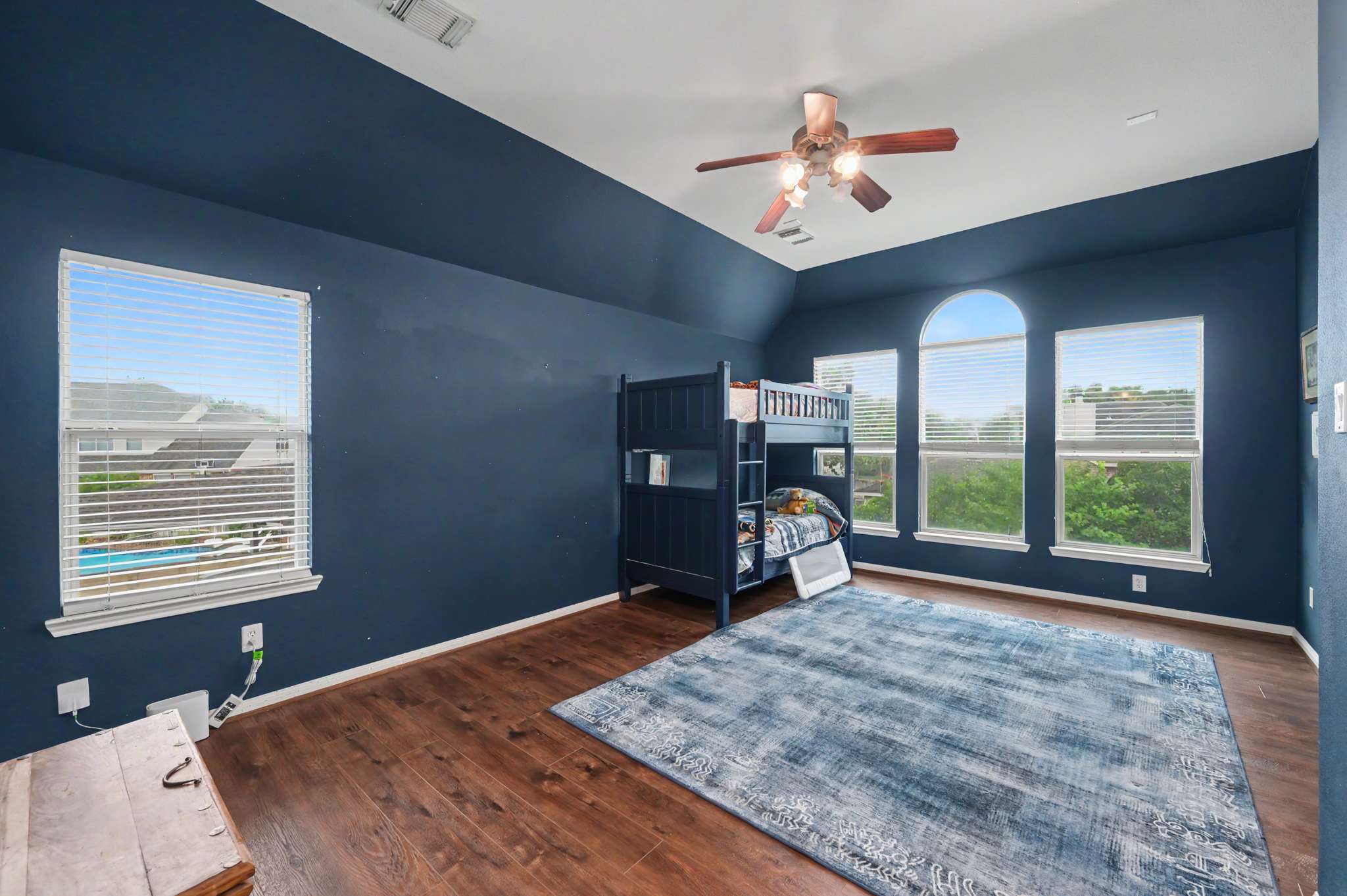 52 of 71. Spacious bedroom featuring a unique bunk bed setup and large windows for ample natural light.