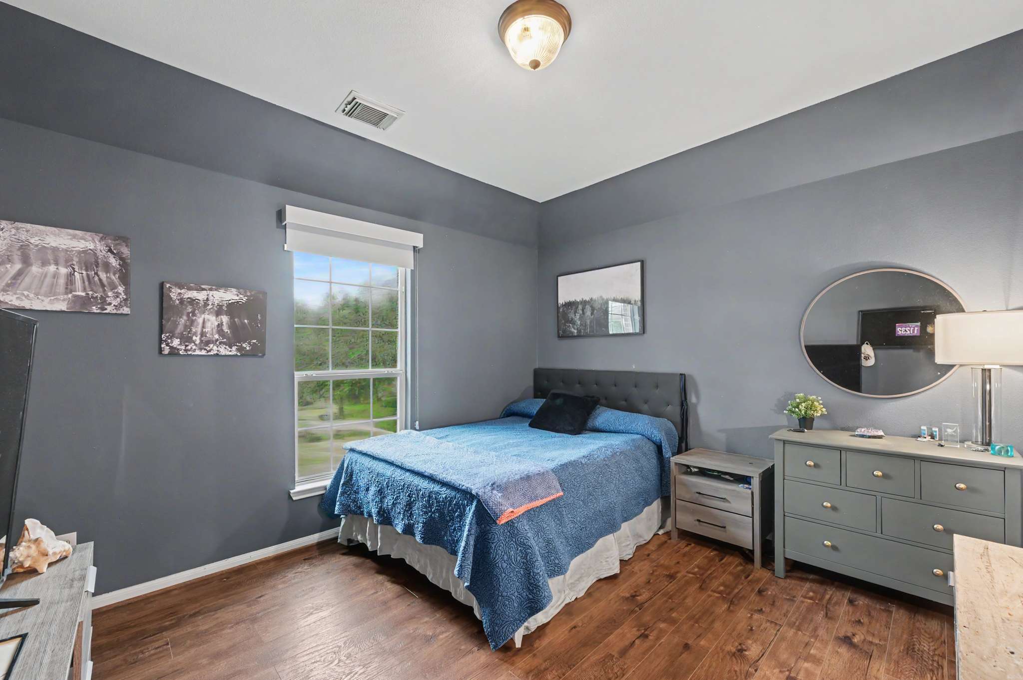 56 of 71. Spacious bedroom featuring contemporary decor, large windows, and ample natural light for a welcoming atmosphere.