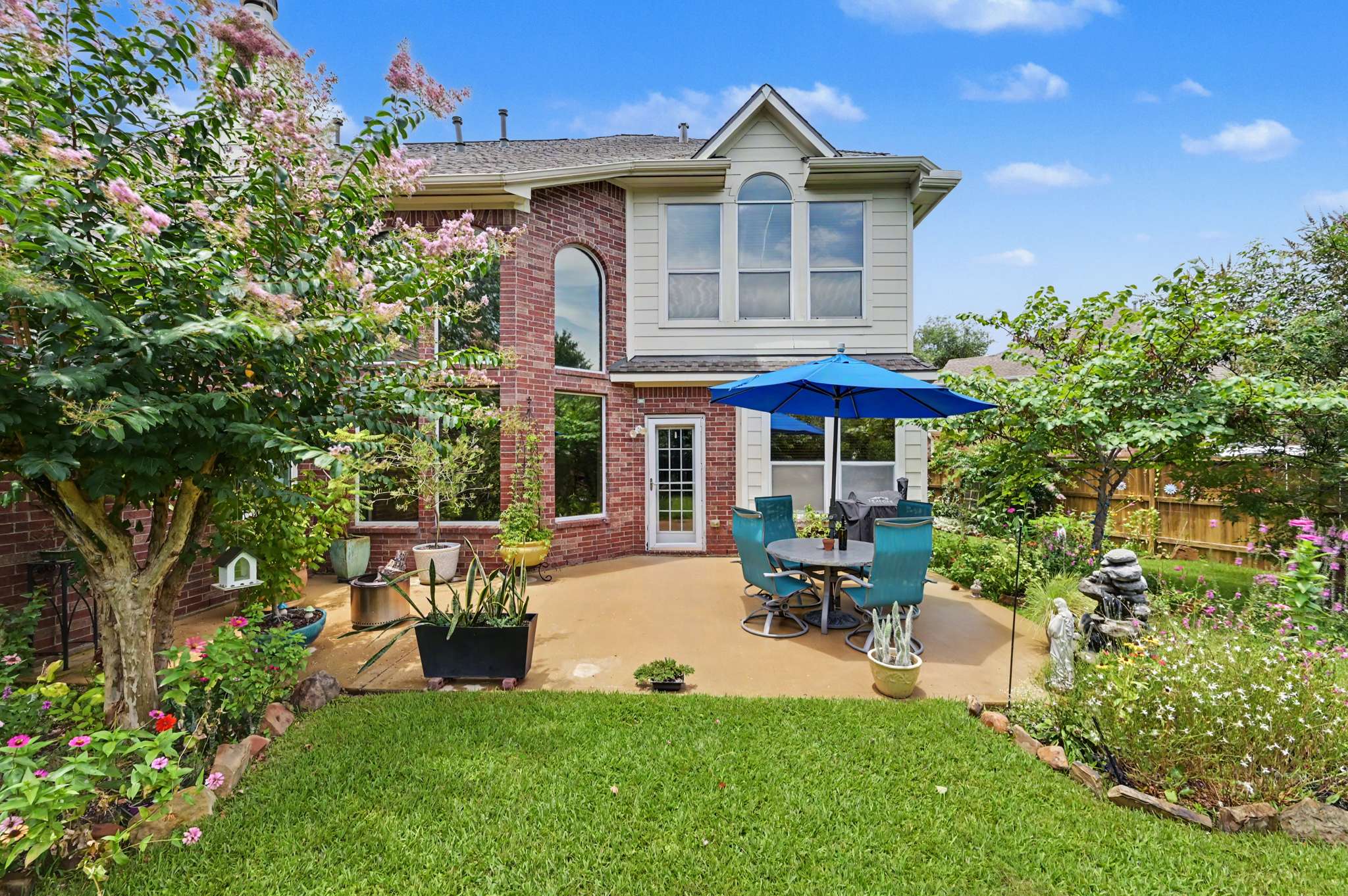 60 of 71. Enjoy outdoor living in this landscaped backyard, perfect for gatherings or quiet moments.