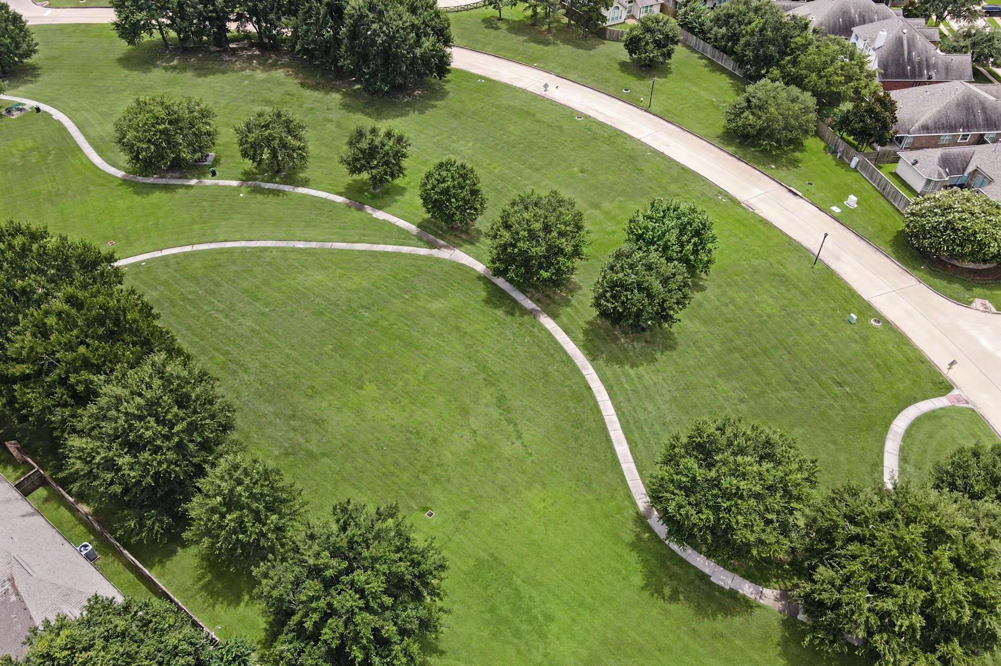 67 of 71. Spacious green park area features winding paths, mature trees, and convenient access to nearby residential neighborhoods.