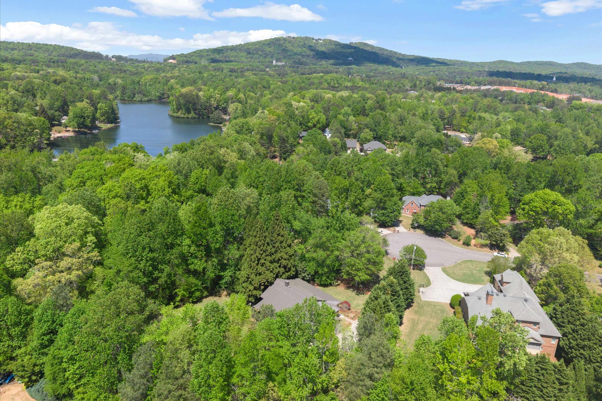 60 of 72. Expansive property featuring lush greenery, scenic views, and proximity to a tranquil lake for outdoor enjoyment.