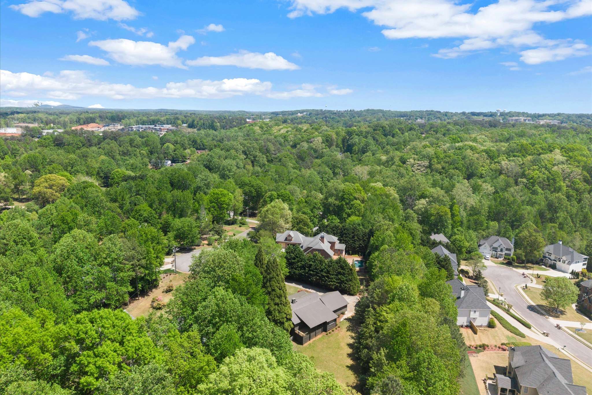 62 of 72. Explore this expansive lot surrounded by lush greenery, offering a perfect blend of nature and community.