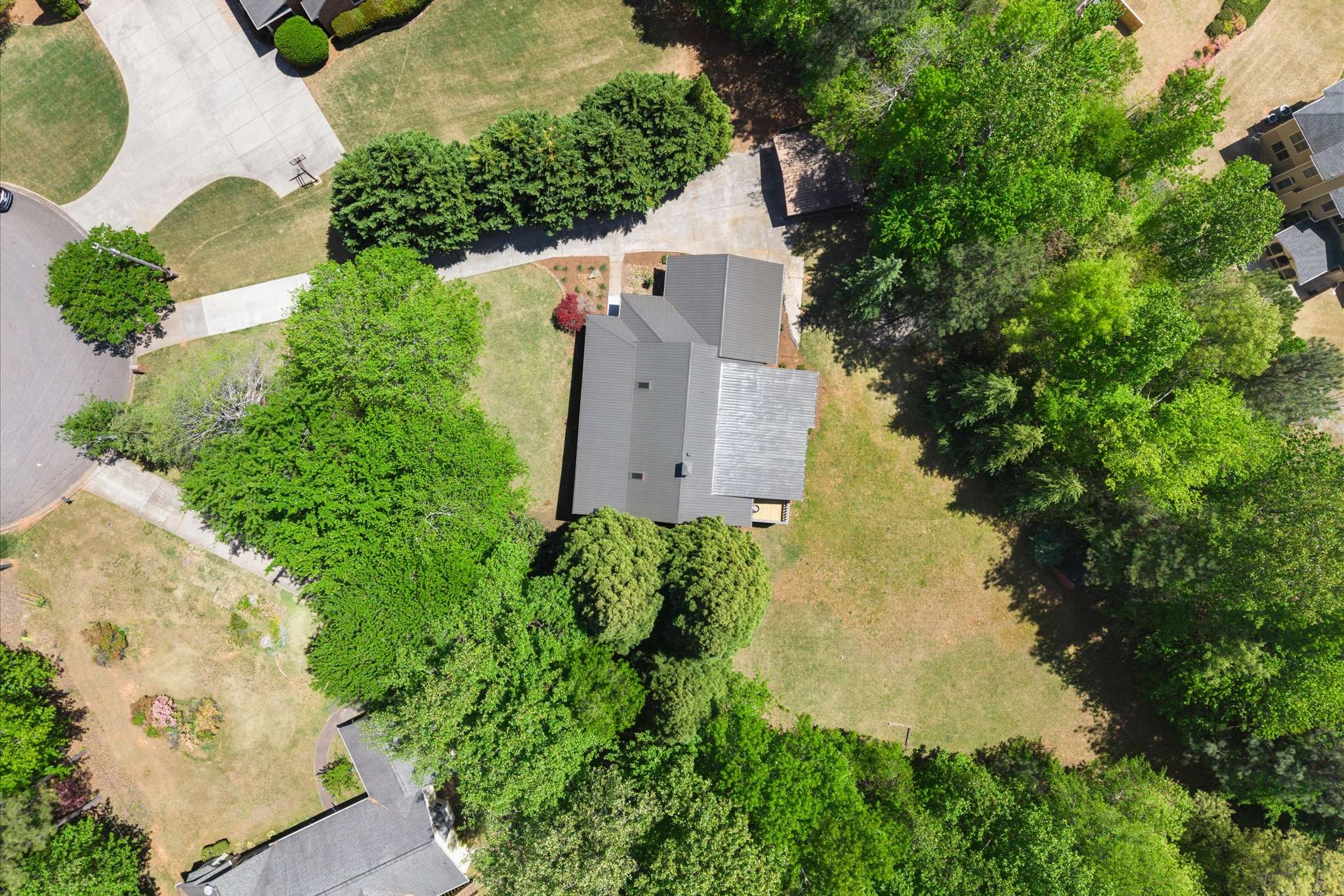 63 of 72. Spacious property surrounded by lush greenery, featuring ample outdoor space and convenient access to local amenities.