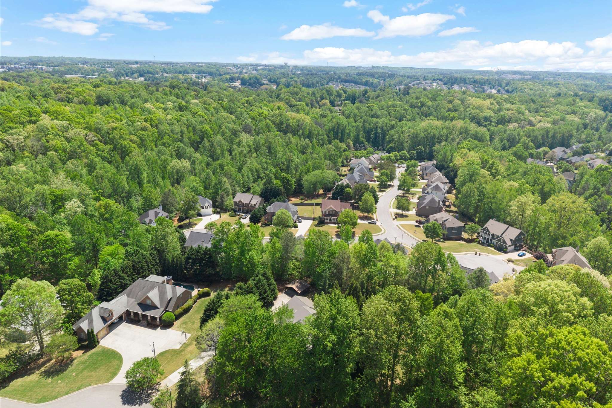 64 of 72. Sprawling community nestled among lush greenery, featuring modern homes and picturesque views throughout the neighborhood.
