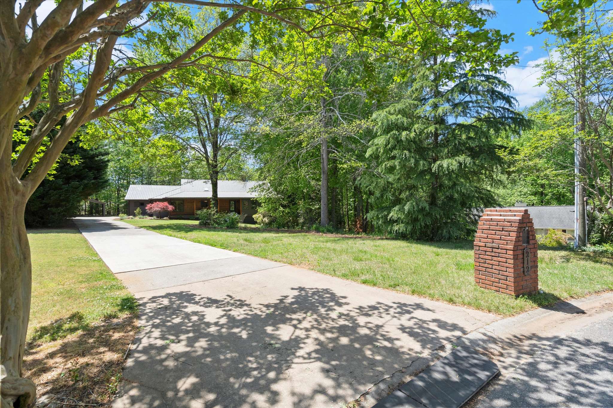 8 of 72. Spacious home set on a large lot, surrounded by lush greenery and ample outdoor space.