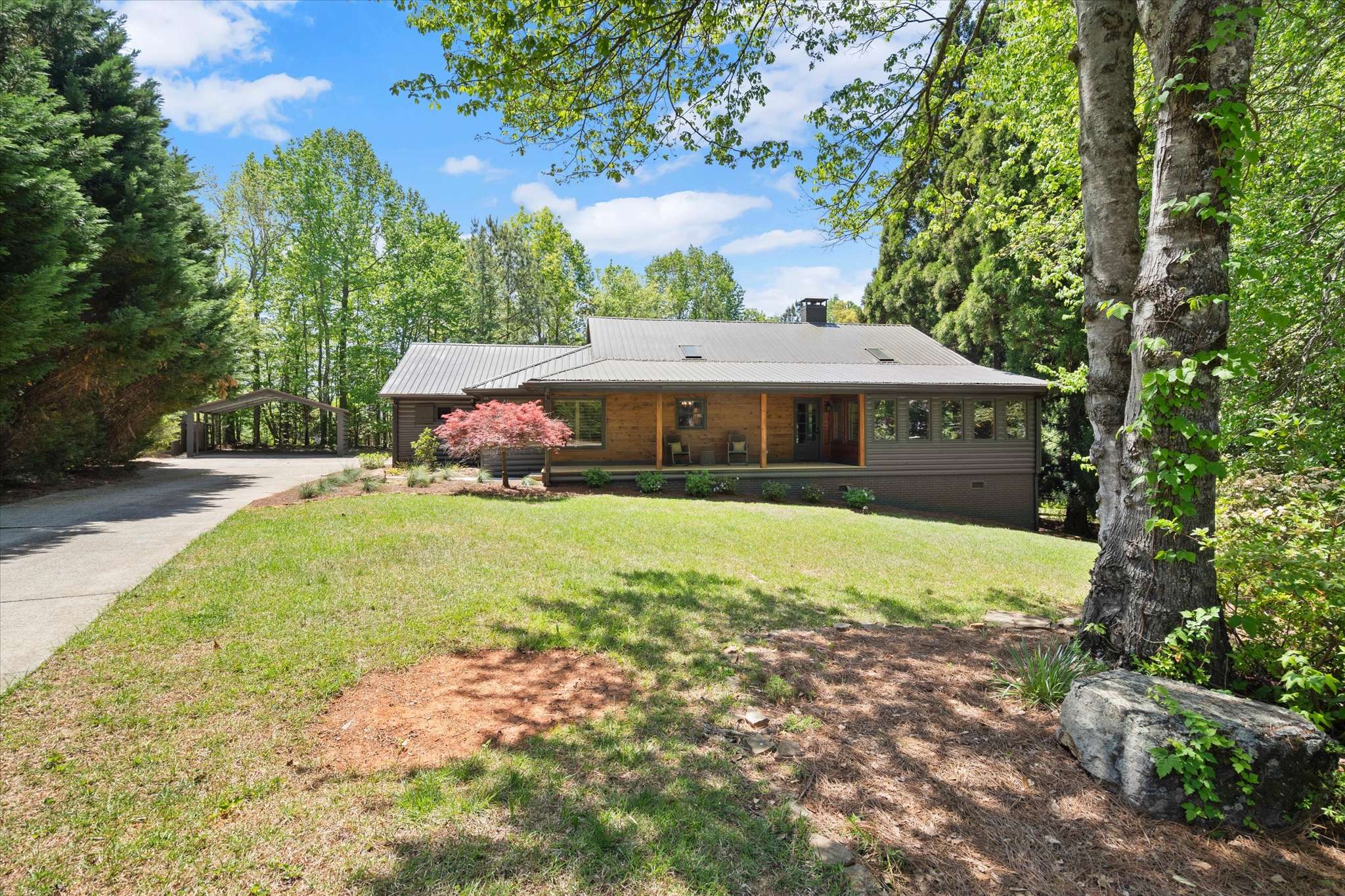 1 of 72. This inviting home features a spacious yard, surrounded by lush greenery and natural light throughout.