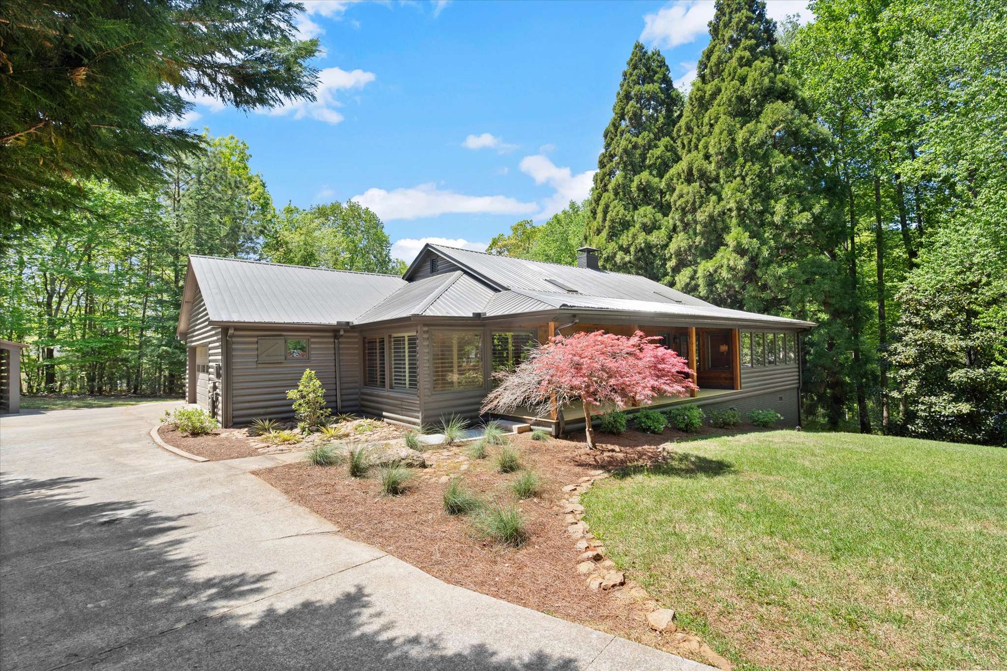9 of 72. Welcoming home surrounded by lush greenery, featuring a spacious layout and beautiful landscaping for outdoor enjoyment.