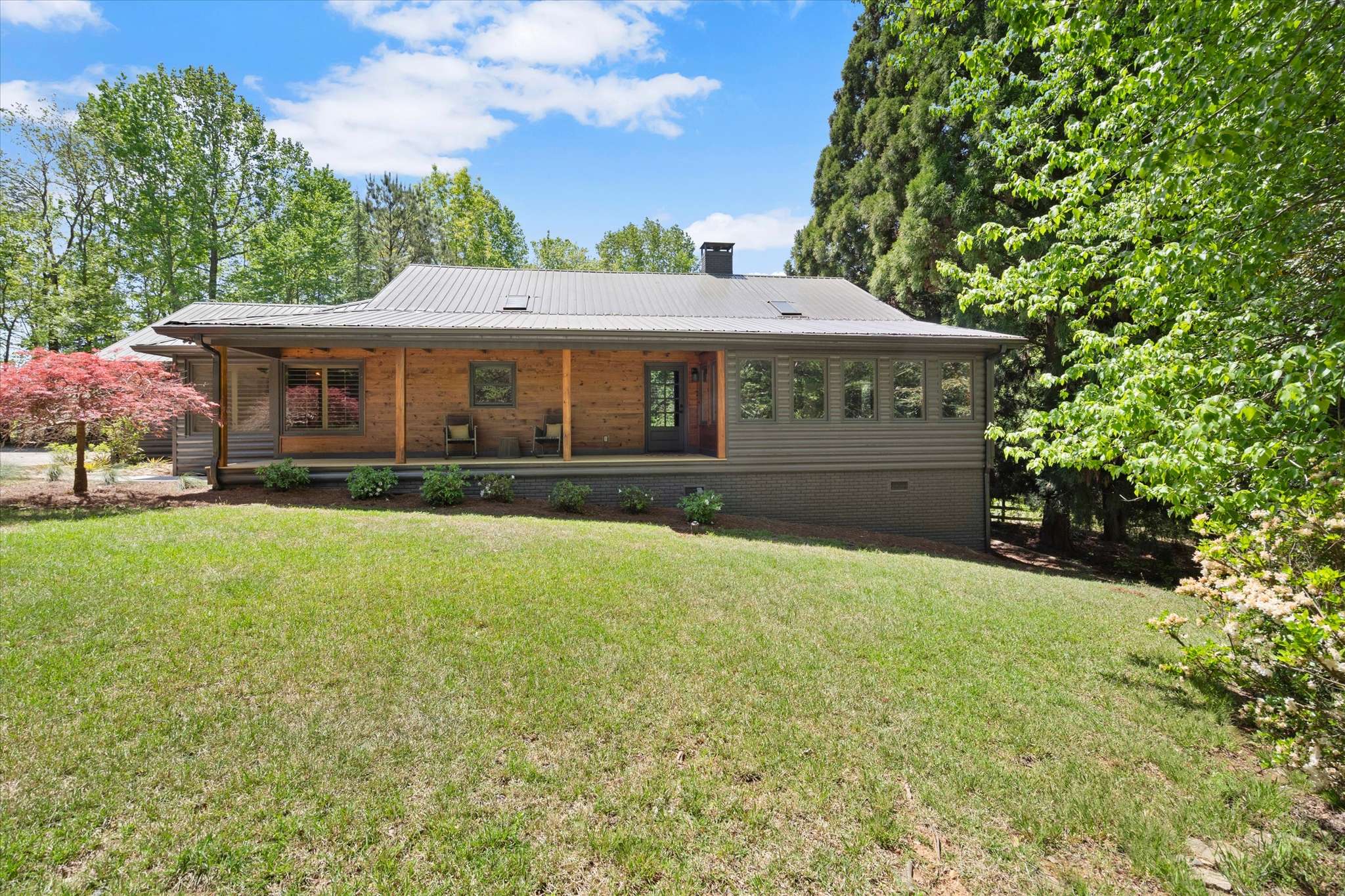 10 of 72. Discover this inviting home, featuring spacious grounds and a cozy porch, perfect for relaxation and gatherings.