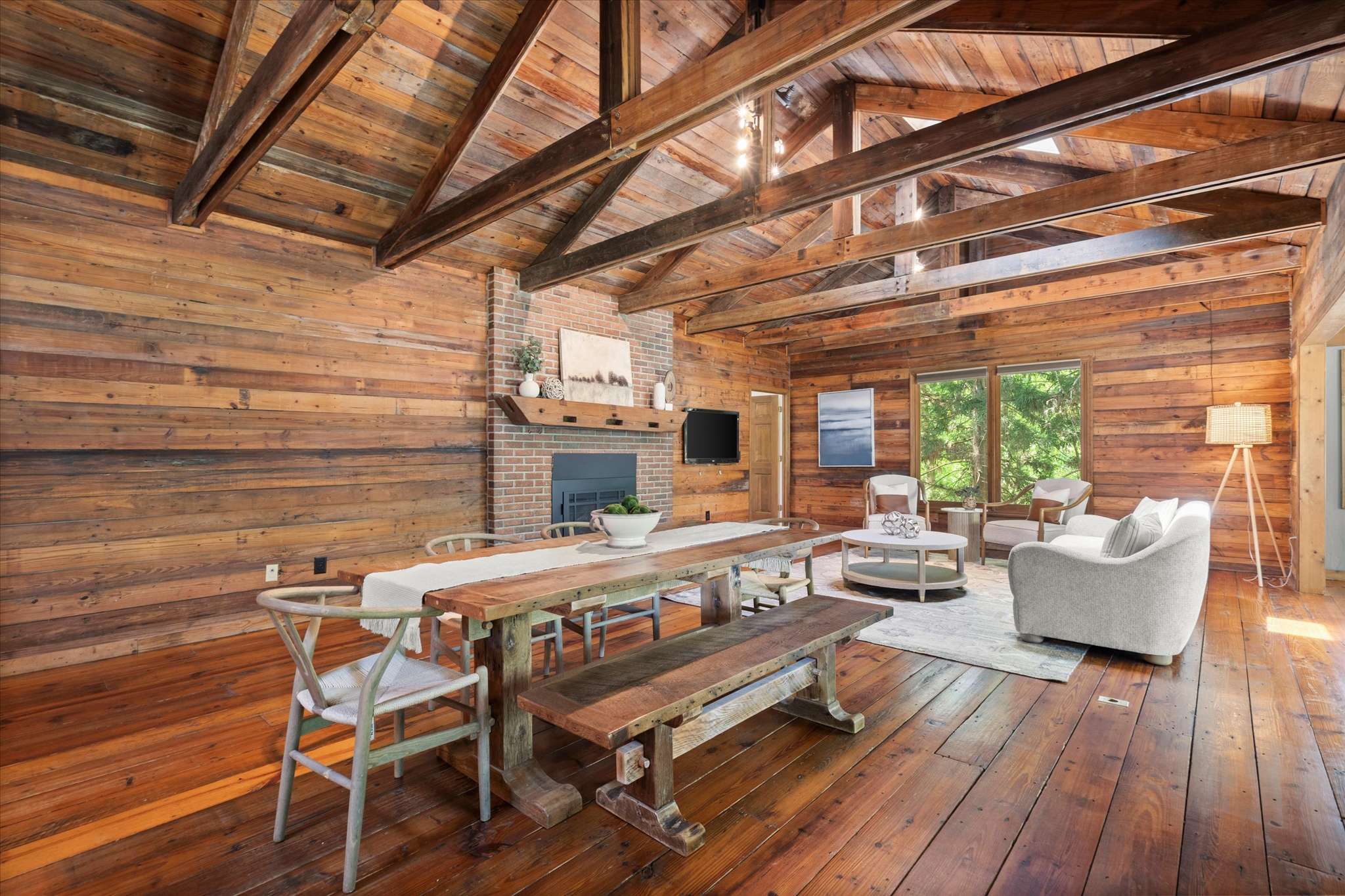 3 of 72. Bright, open space featuring natural wood beams, a cozy fireplace, and inviting dining area for gatherings.