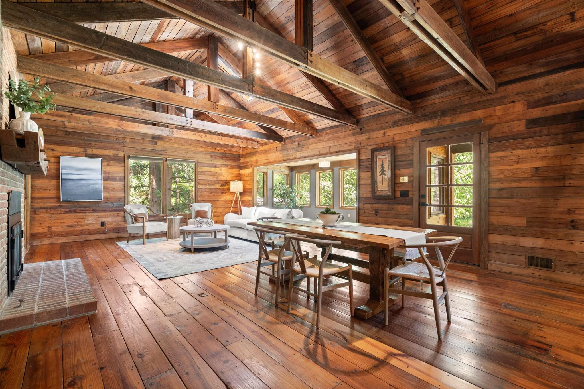 4 of 72. Spacious open-concept living area featuring natural wood finishes and abundant light through large windows.