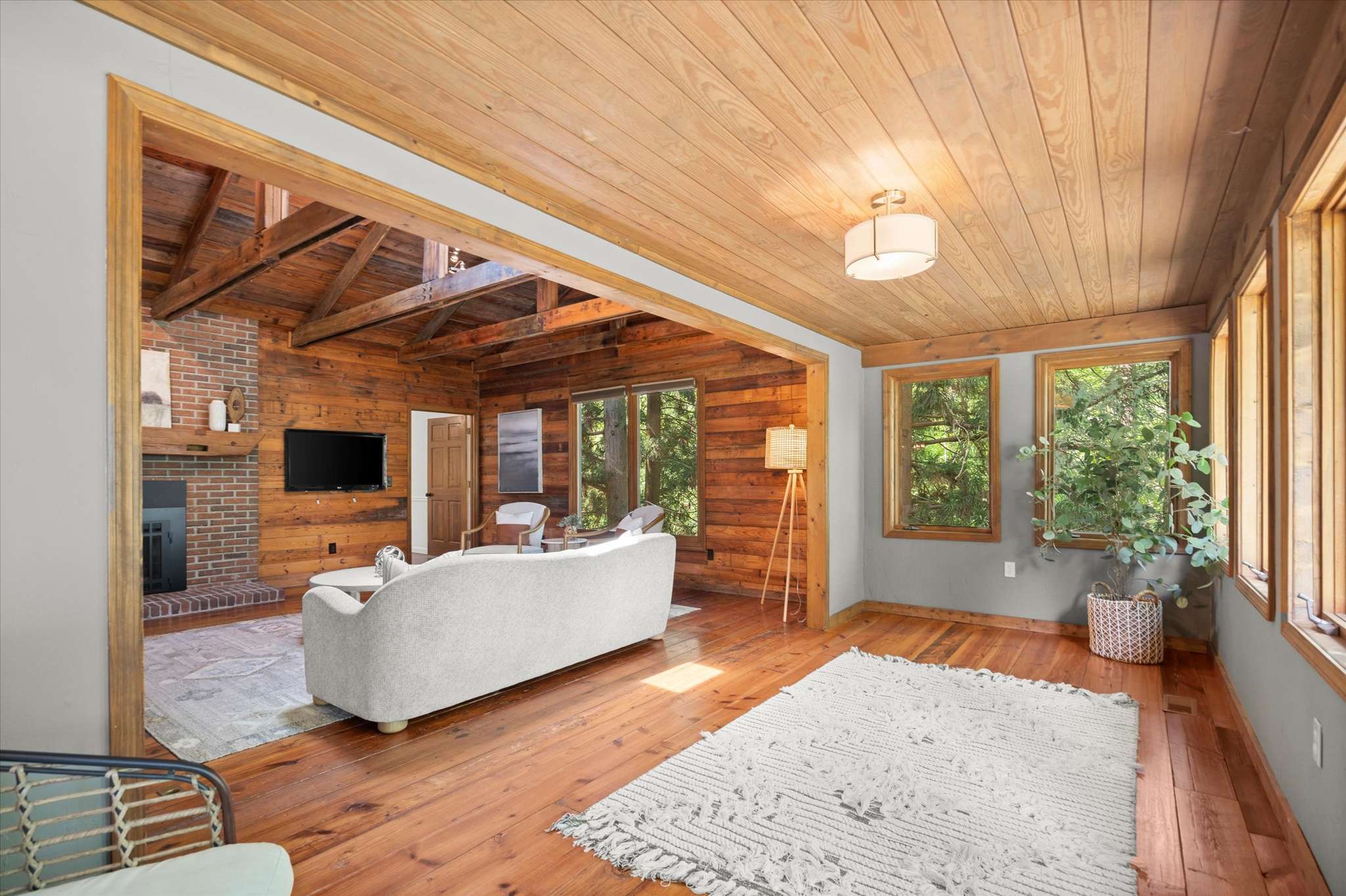 21 of 72. Bright, open living space featuring natural wood accents and large windows that invite the outdoors in.