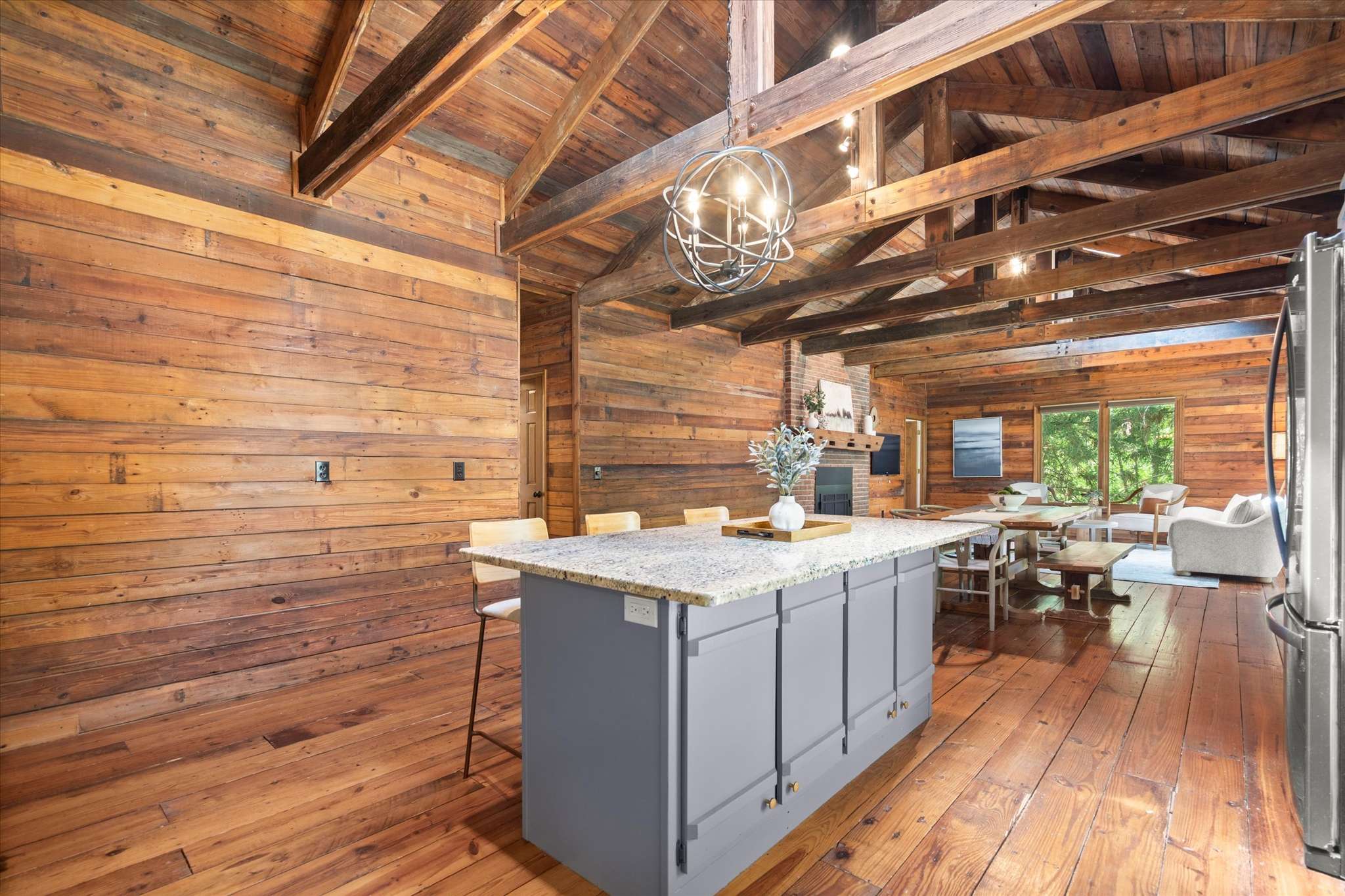26 of 72. Rustic kitchen featuring a spacious island and rich wooden accents, perfect for gatherings and culinary creativity.