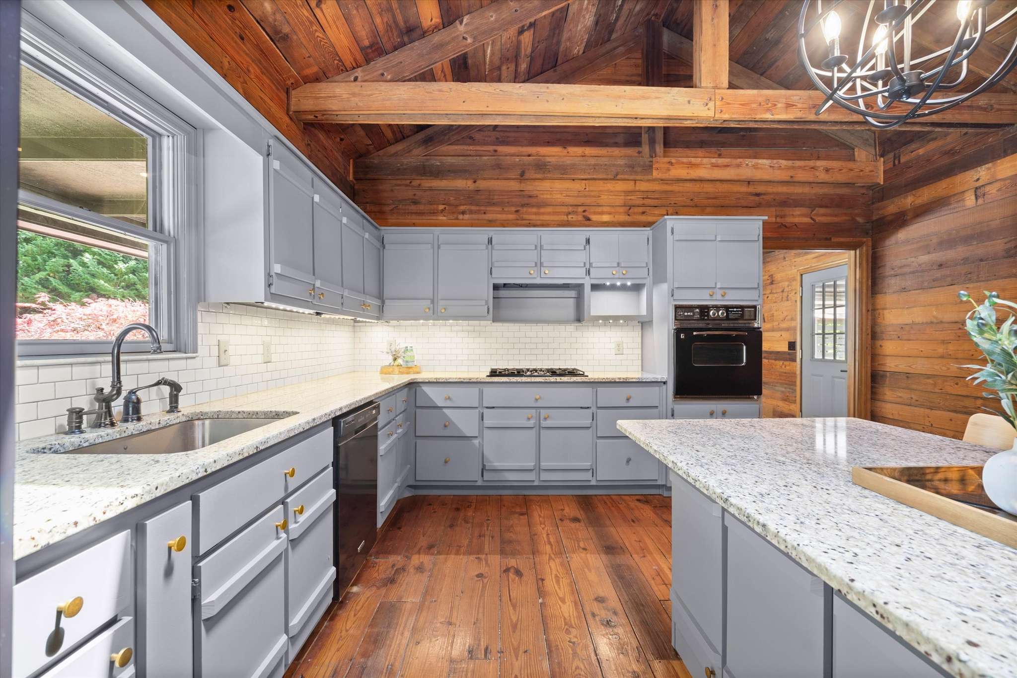 27 of 72. Discover this inviting kitchen featuring modern amenities, abundant natural light, and beautiful wood accents.
