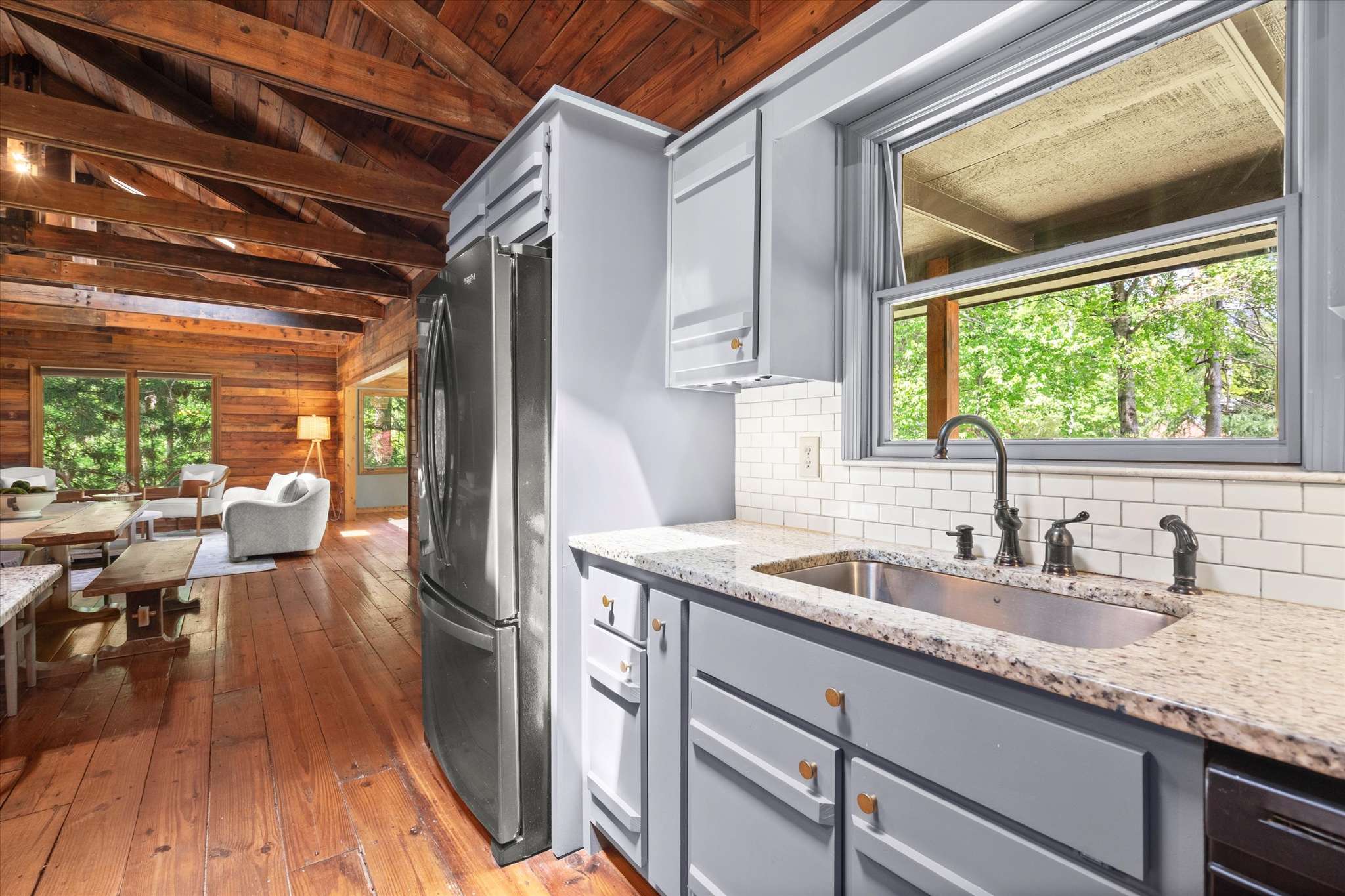 29 of 72. Bright and inviting kitchen with modern appliances, showcasing natural light and a seamless flow to the living area.