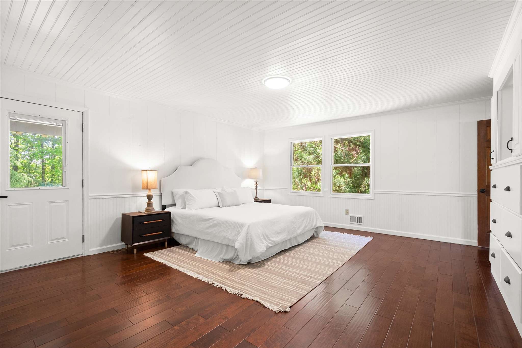 33 of 72. Bright and airy bedroom featuring a spacious layout, natural light, and easy access to outdoor views.