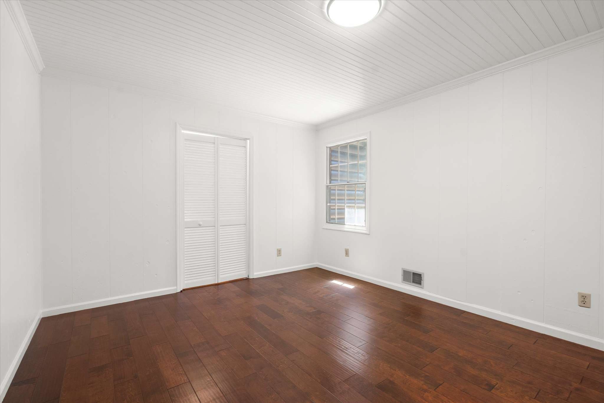 39 of 72. Bright and airy room featuring hardwood floors and ample natural light, perfect for various uses.