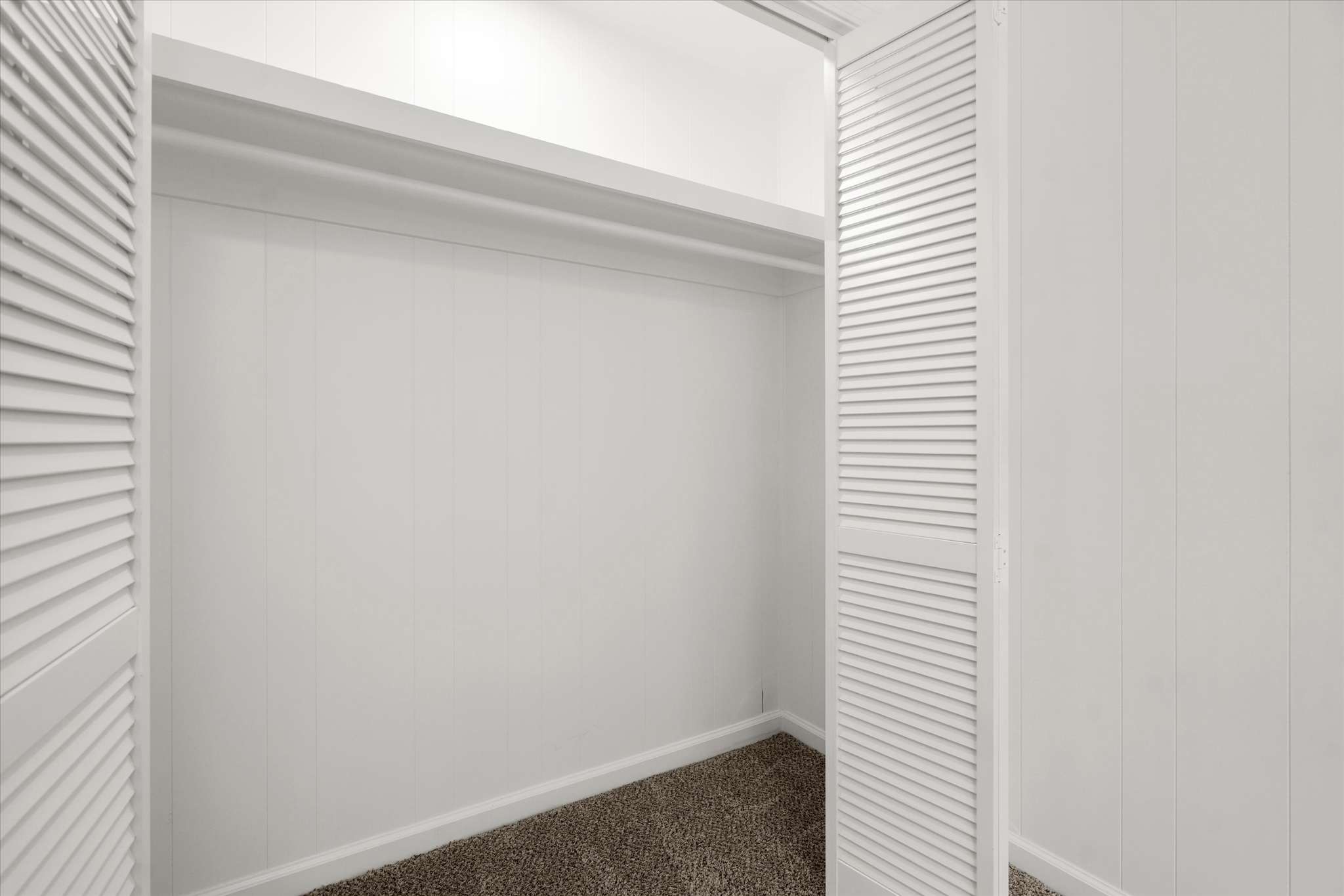 44 of 72. Spacious closet with ample storage space, featuring double doors and clean, modern finishes.
