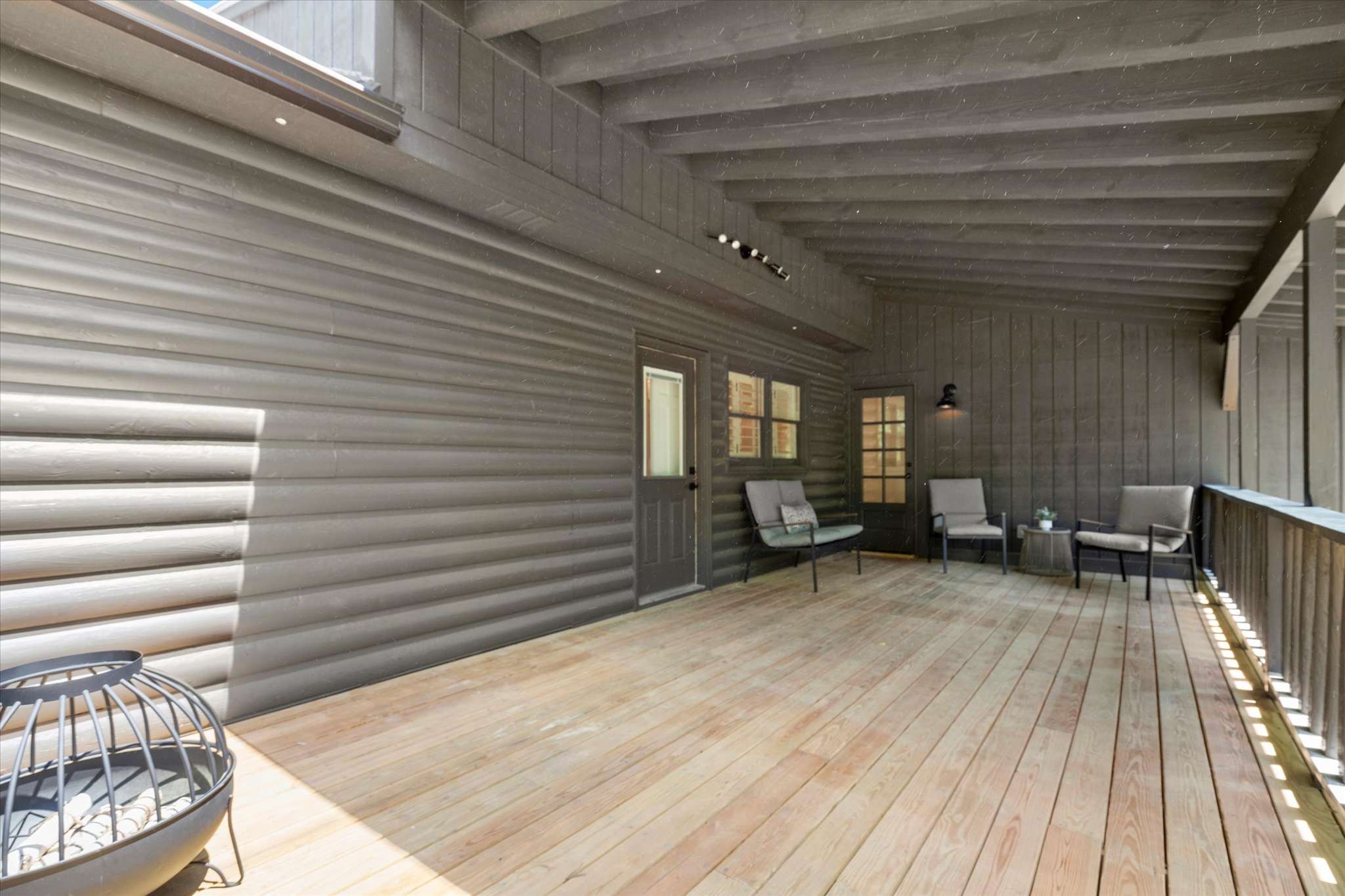 46 of 72. Spacious covered deck features wood flooring, perfect for outdoor gatherings and relaxation in any weather.