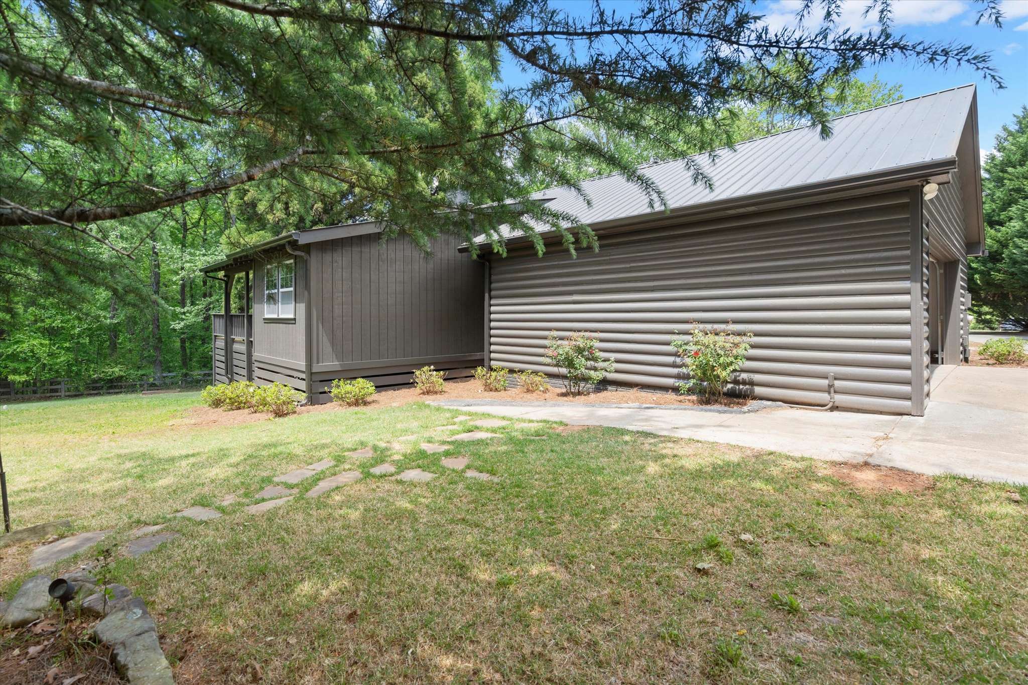 51 of 72. This unique log cabin features a spacious yard and a blend of natural surroundings and modern living.