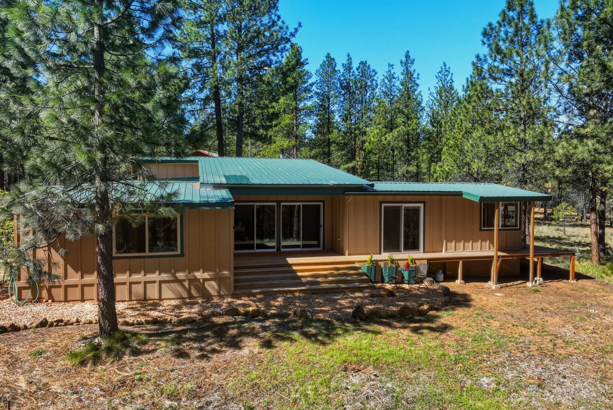 54 of 61. This cozy home nestled among tall pines offers a perfect blend of comfort and nature.