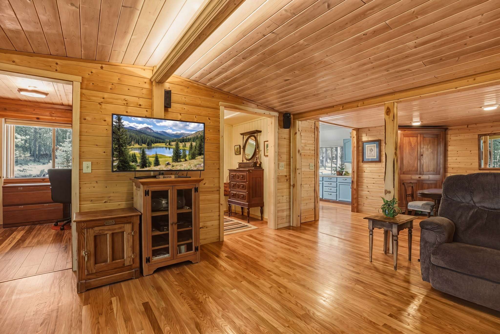 22 of 61. Cozy living area features natural wood finishes and ample sunlight, creating a warm, inviting atmosphere.